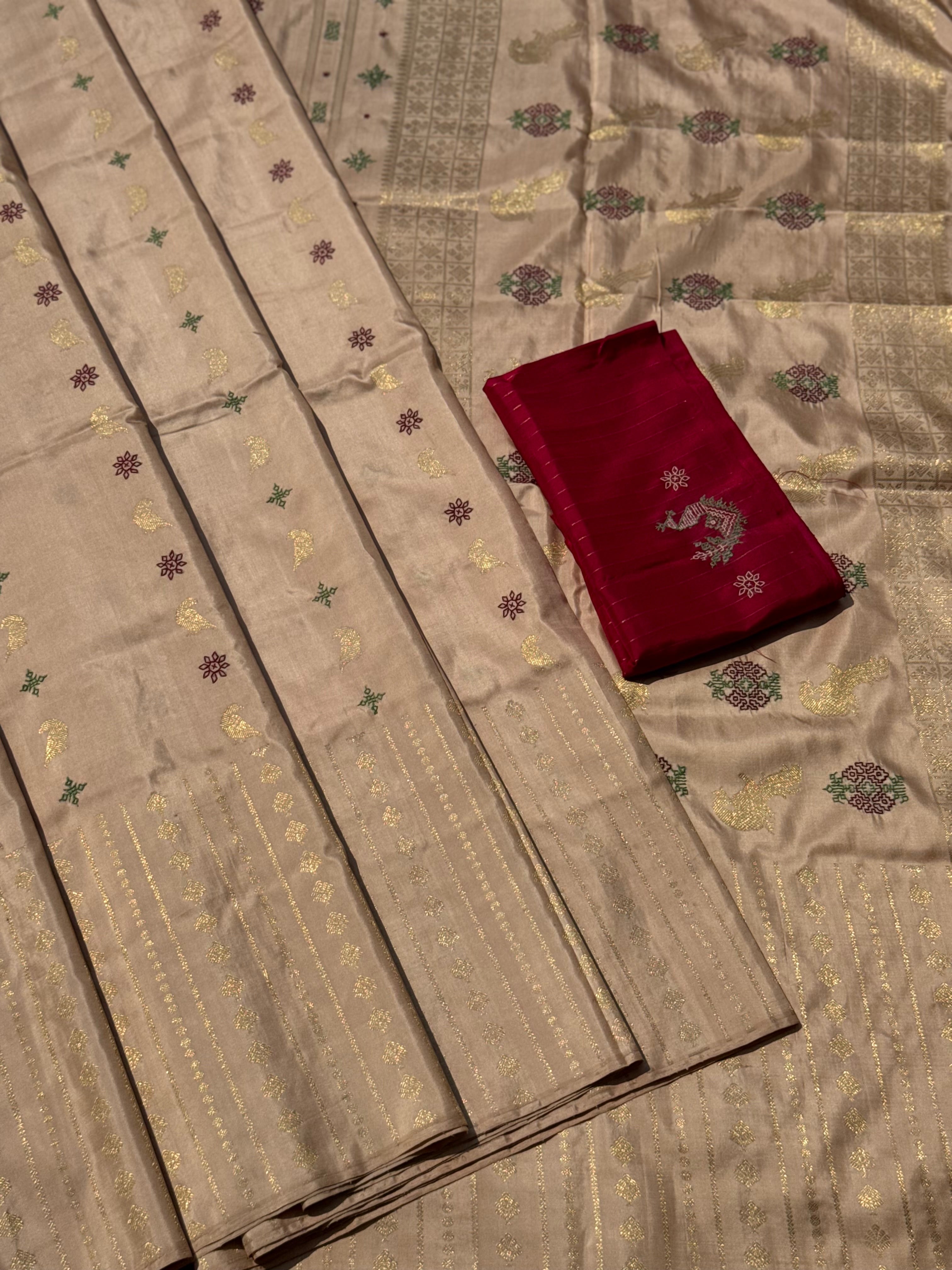 A designer exclusive almond shaded borderless kanchivaram silk saree With hand embroidered kasuti work