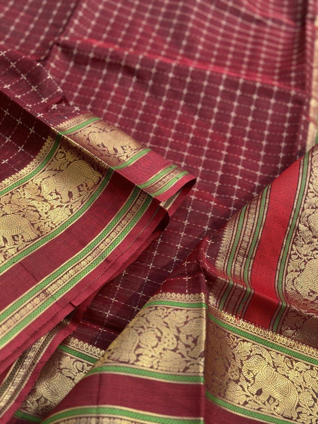 A gorgeous burgundy shade handwoven plus buttas silk cotton saree