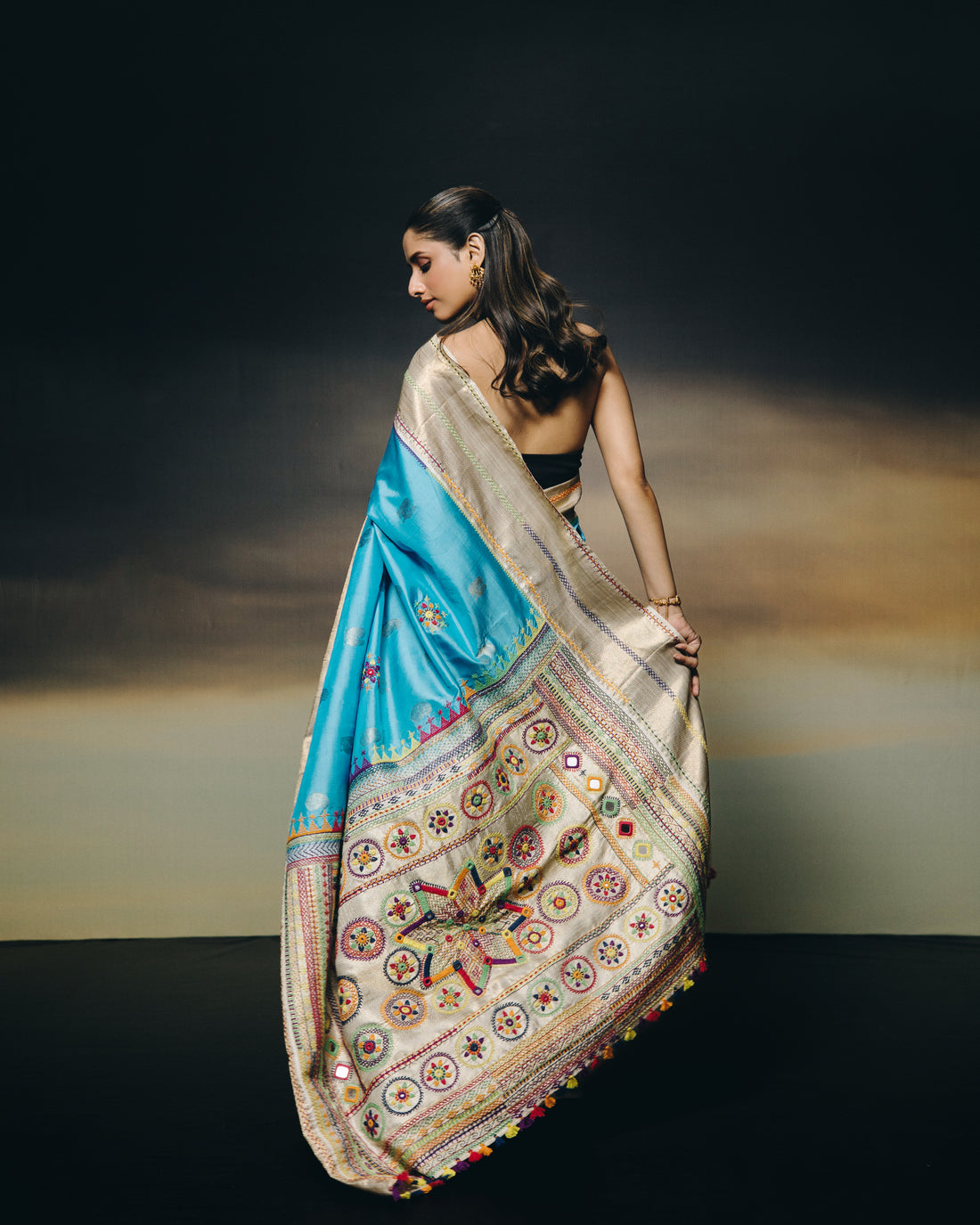 handwoven pure kanchivaram silk saree with korvai borders adorned with an exquisite handmade lambani mirror work