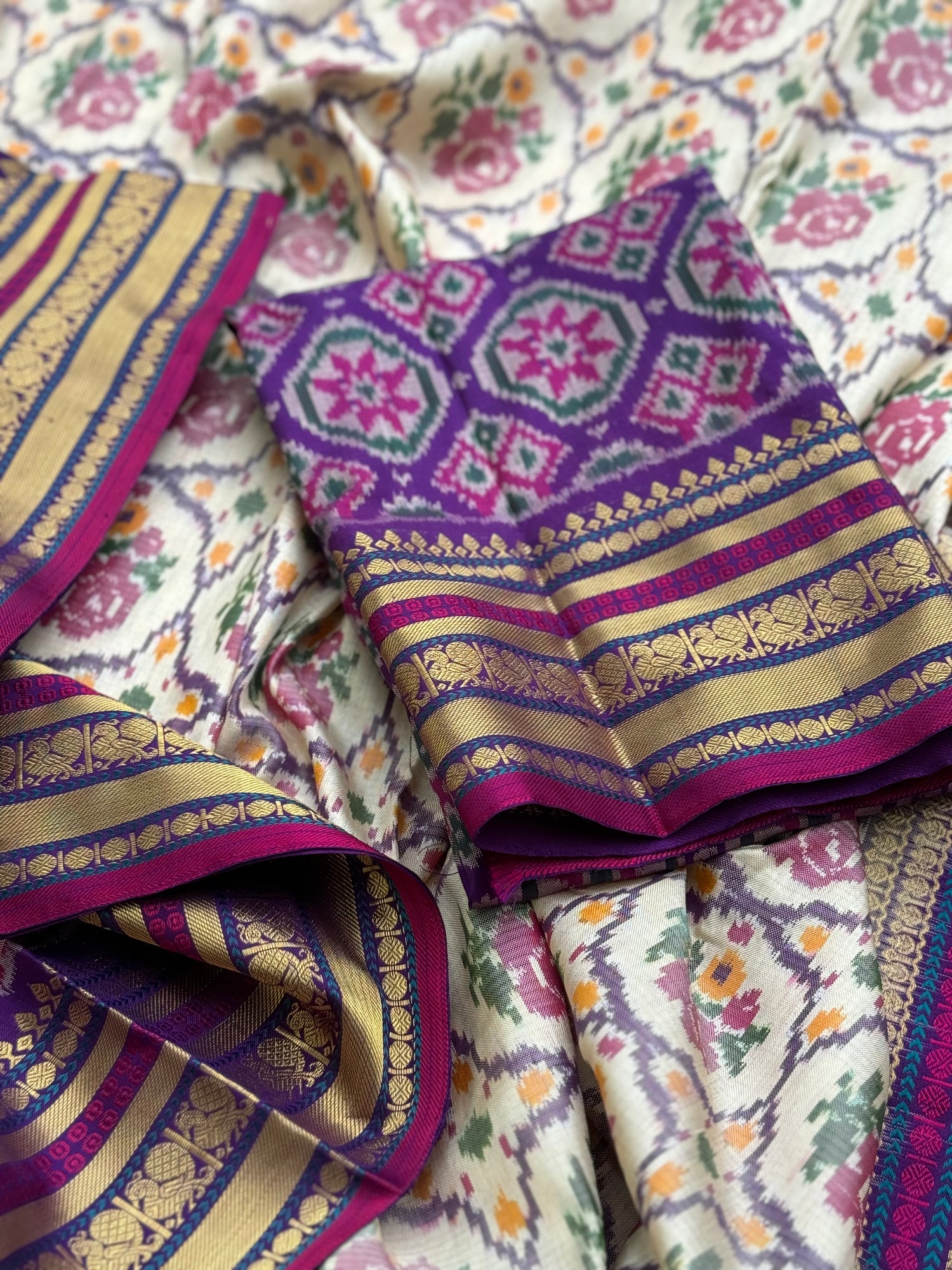 A masterpiece ivory with purple roses patola inspired ikkat with kanchi fusion pure handwoven silk saree