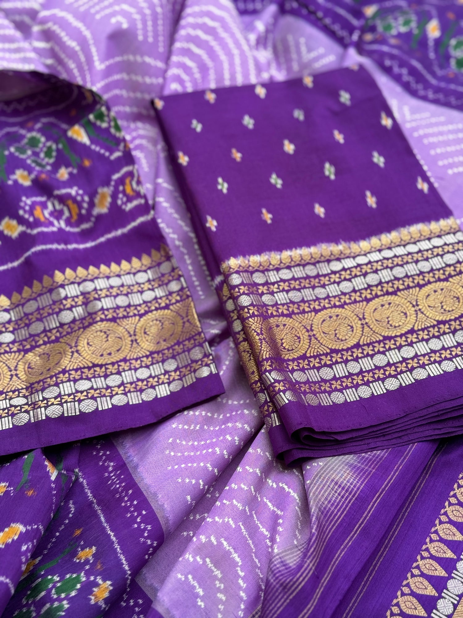 A gorgeous lilac shade handwoven ikkat with kanchi border silk saree