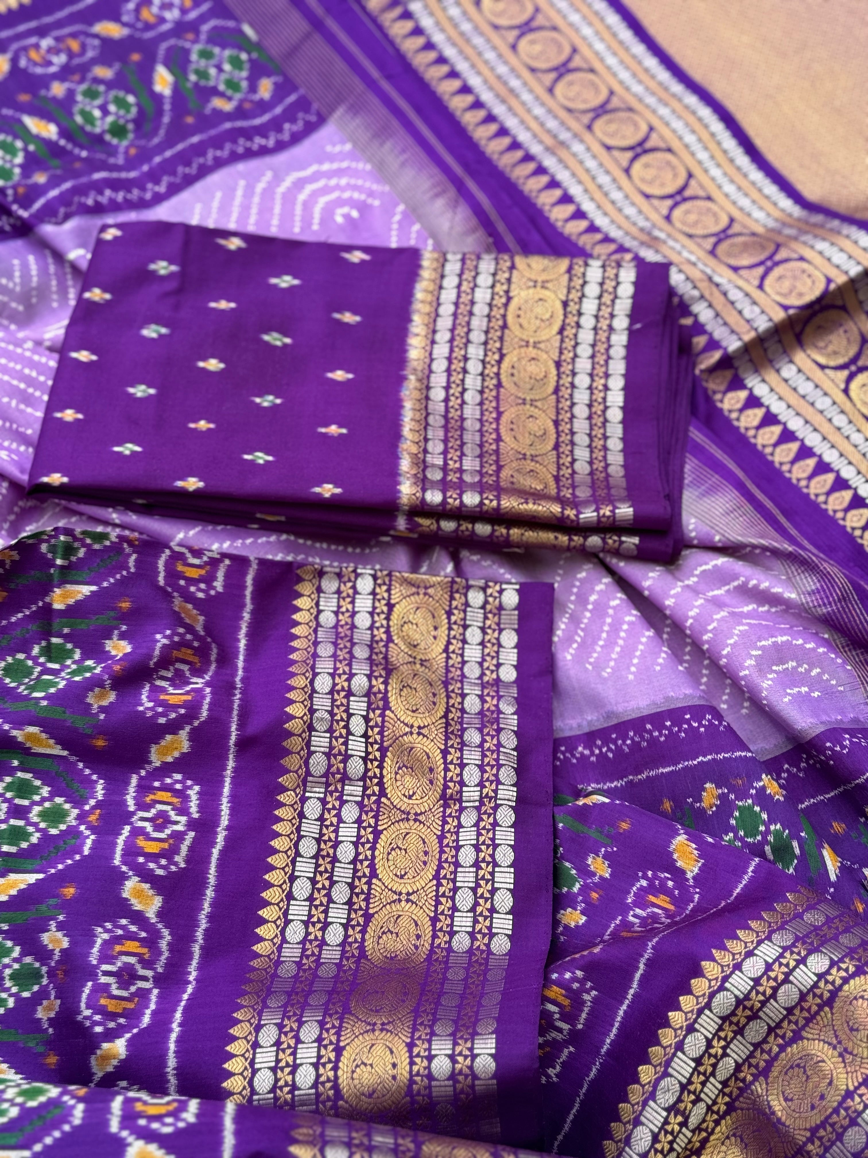 A gorgeous lilac shade handwoven ikkat with kanchi border silk saree