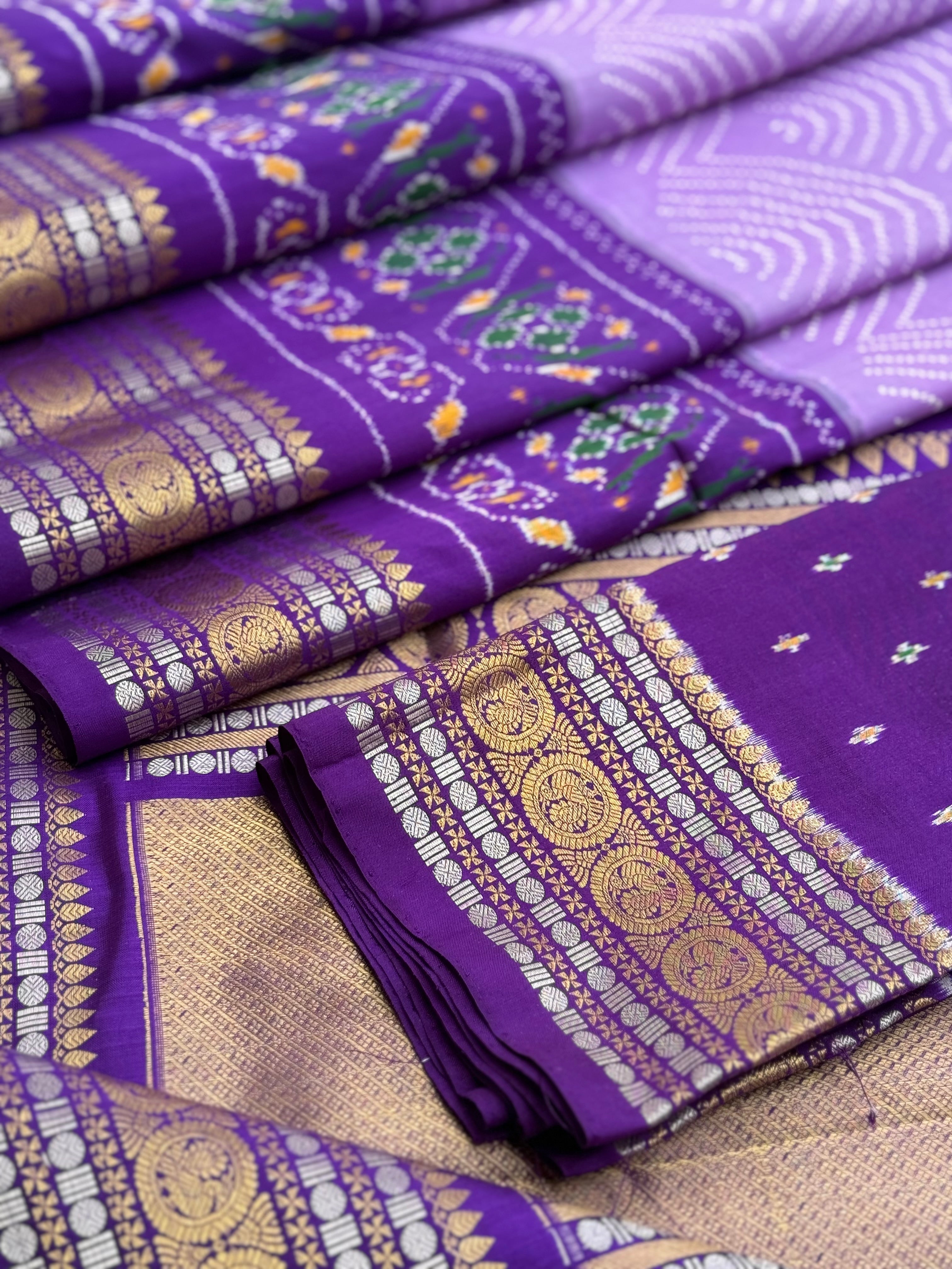 A gorgeous lilac shade handwoven ikkat with kanchi border silk saree