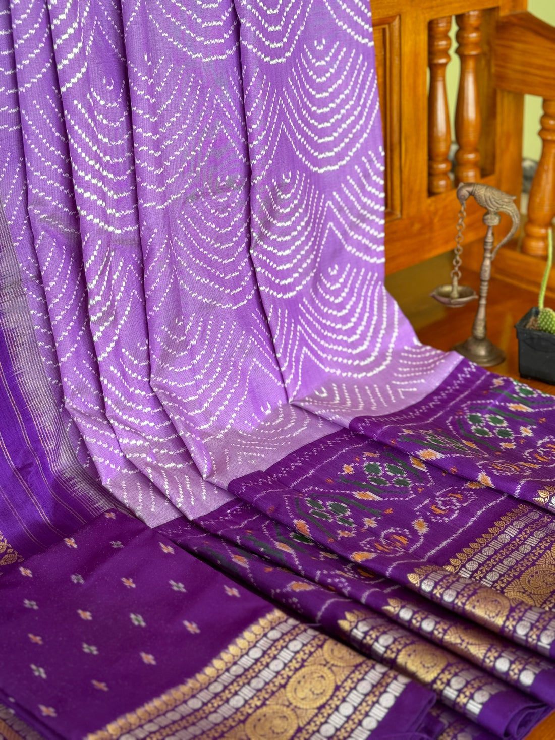 A gorgeous lilac shade handwoven ikkat with kanchi border silk saree