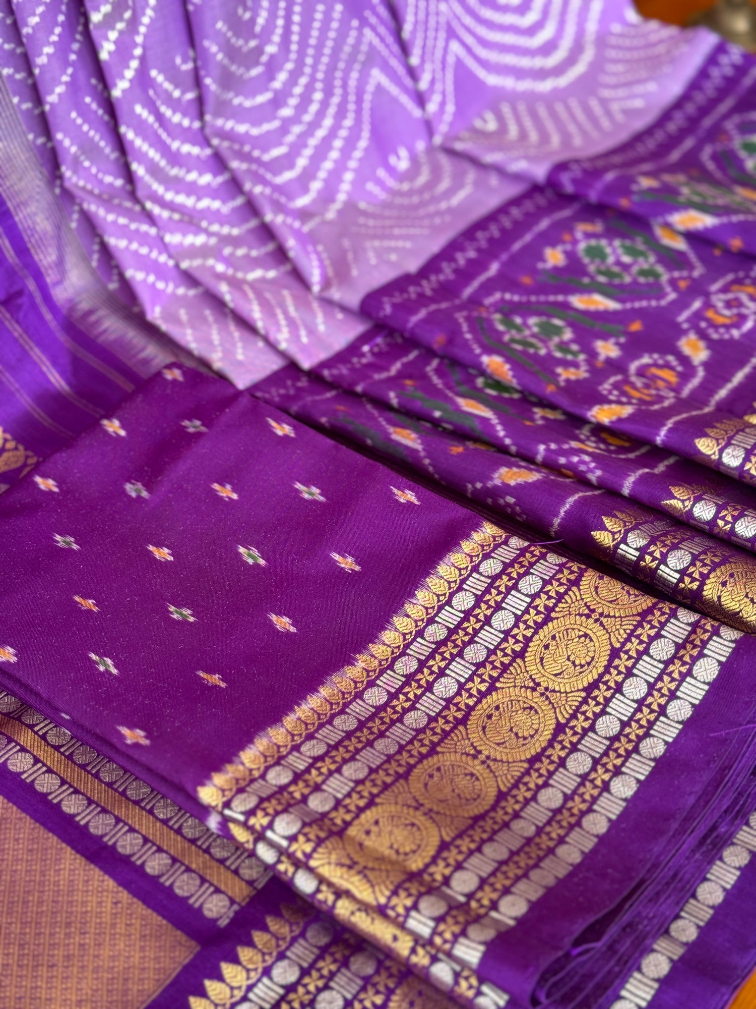 A gorgeous lilac shade handwoven ikkat with kanchi border silk saree