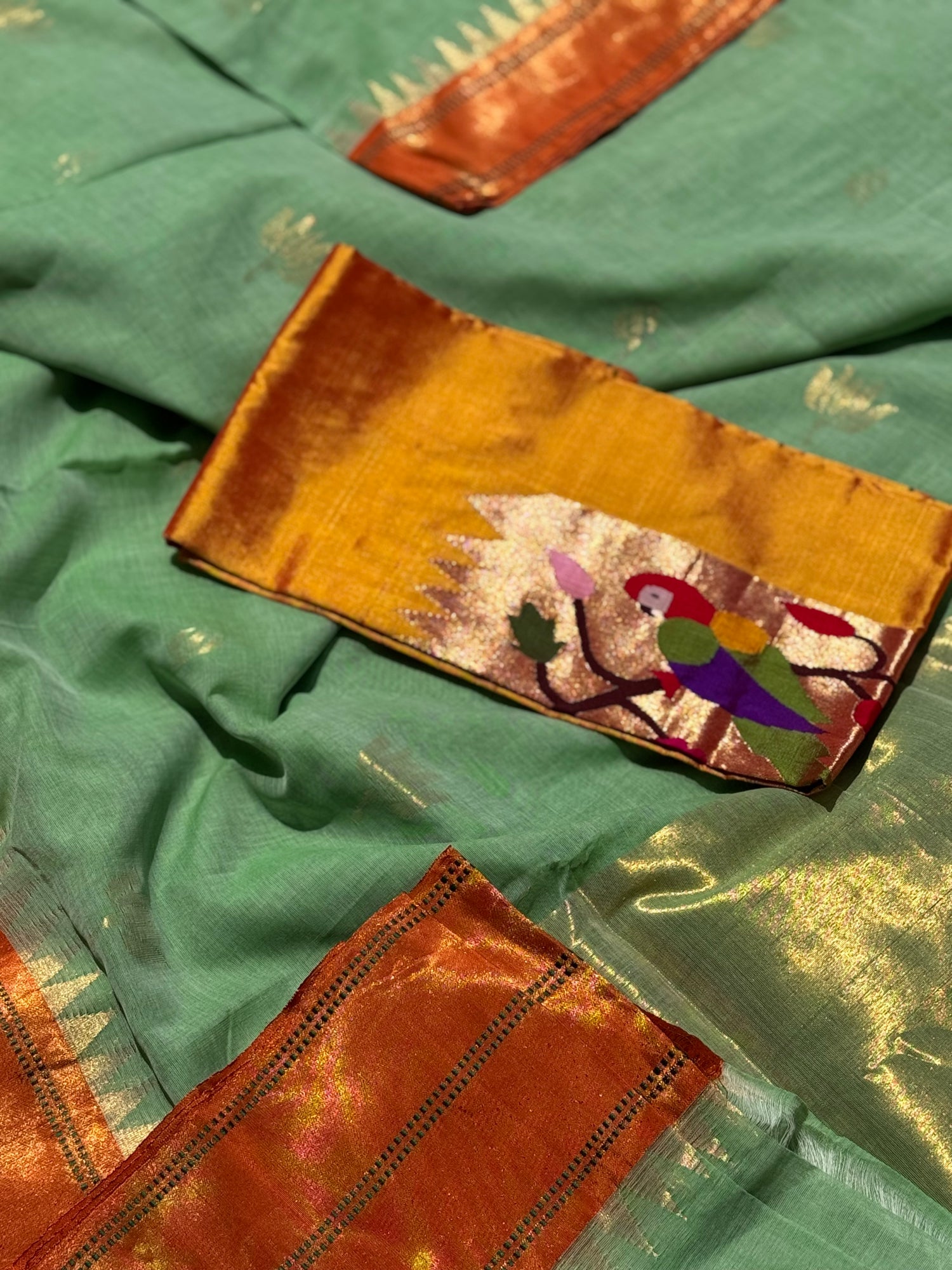 A gorgeous sage green with orange shade handspun ponduru Khadhi jamdani cotton saree