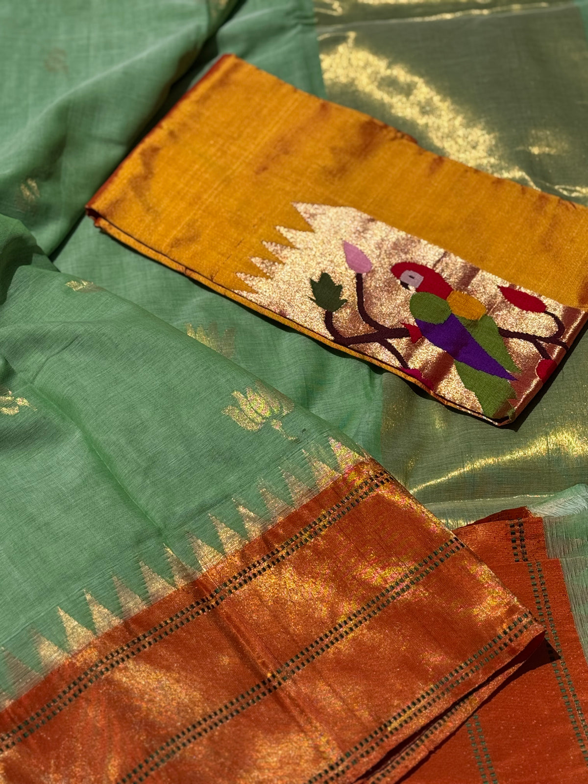 A gorgeous sage green with orange shade handspun ponduru Khadhi jamdani cotton saree