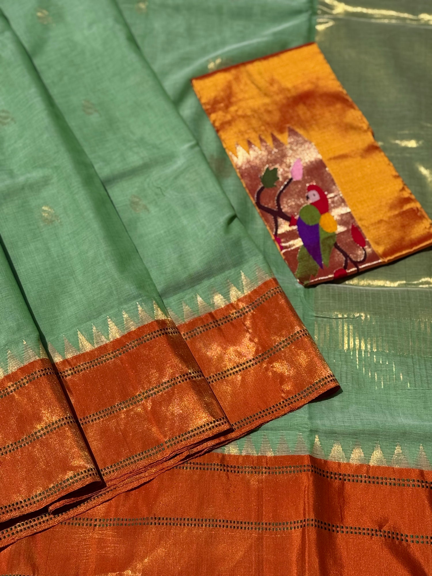 A gorgeous sage green with orange shade handspun ponduru Khadhi jamdani cotton saree