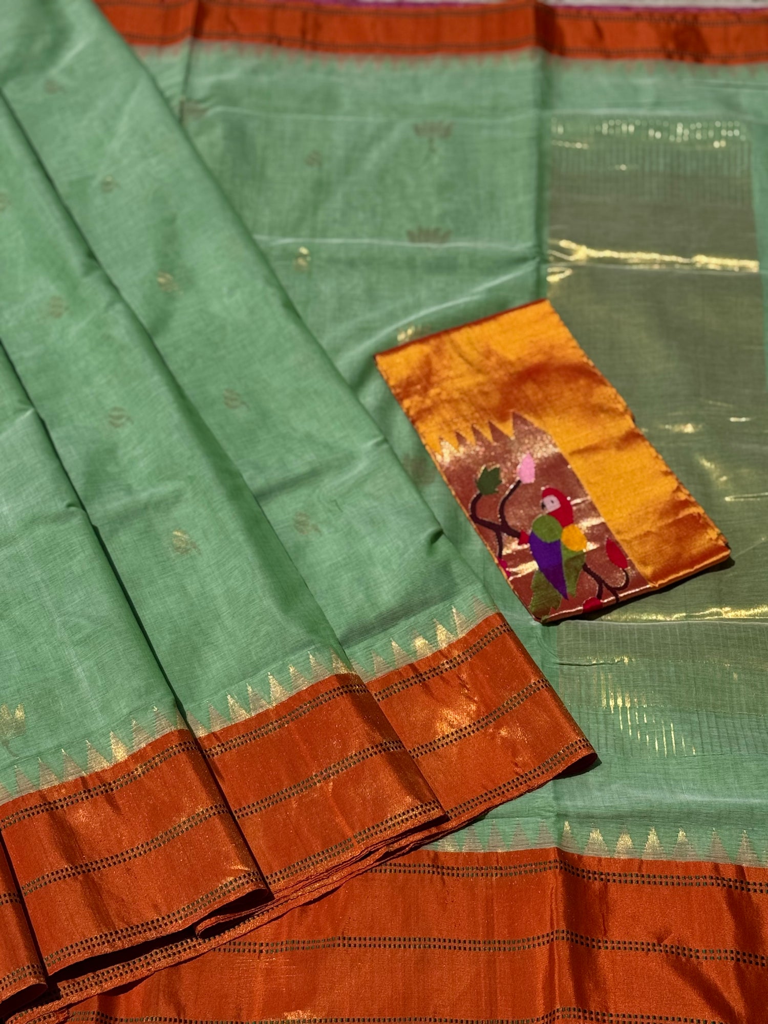A gorgeous sage green with orange shade handspun ponduru Khadhi jamdani cotton saree
