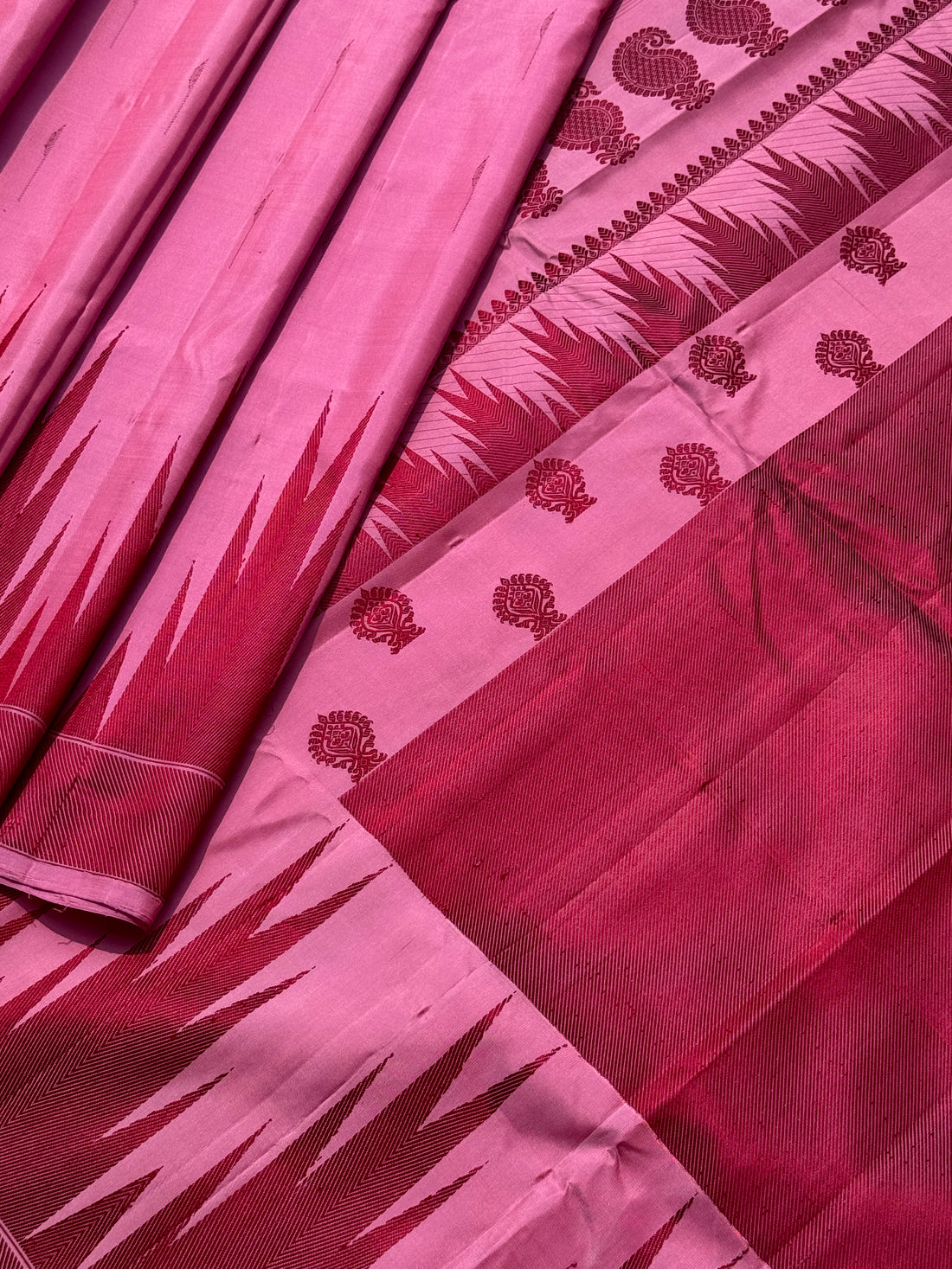 A gorgeous Pastel pink with plum shade handwoven soft and lustrous temple woven gadwal silk saree