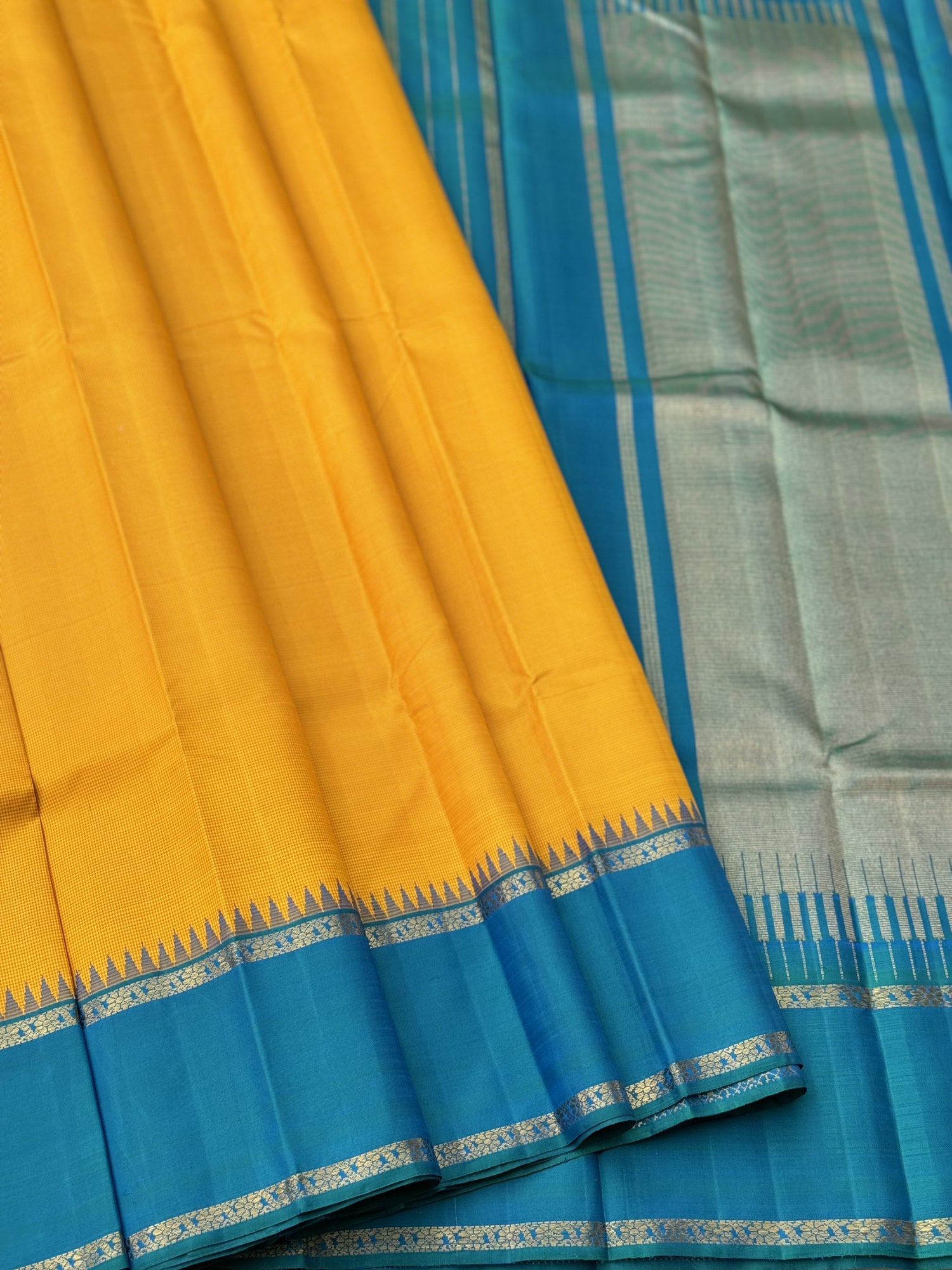 A gorgeous peacock blue with mustard yellow korvai border kanchivaram silk SAREE