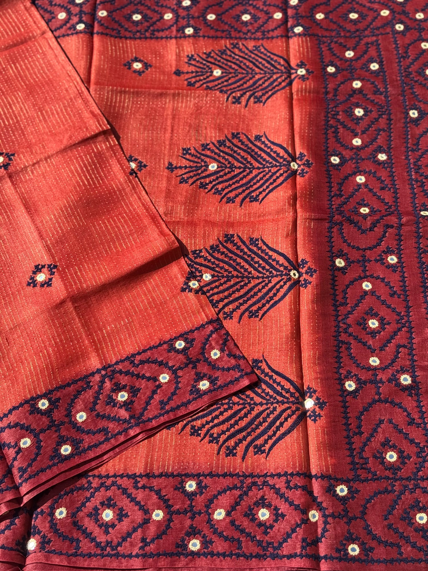 Brick red handwoven Tussar silk saree with handmade kutch mirror embroidery work