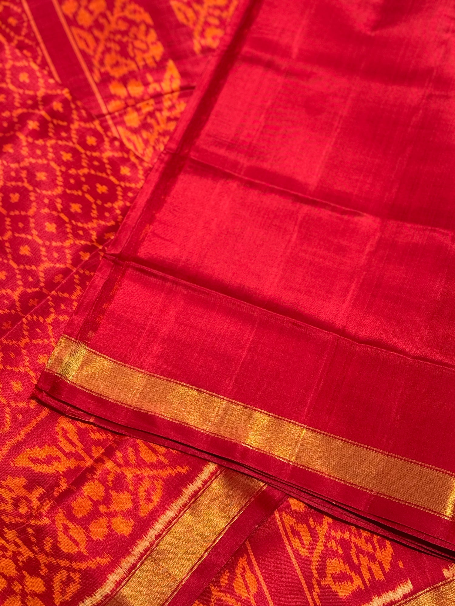 A gorgeous burnt orange with red shade single ikkat patola silk SAREE