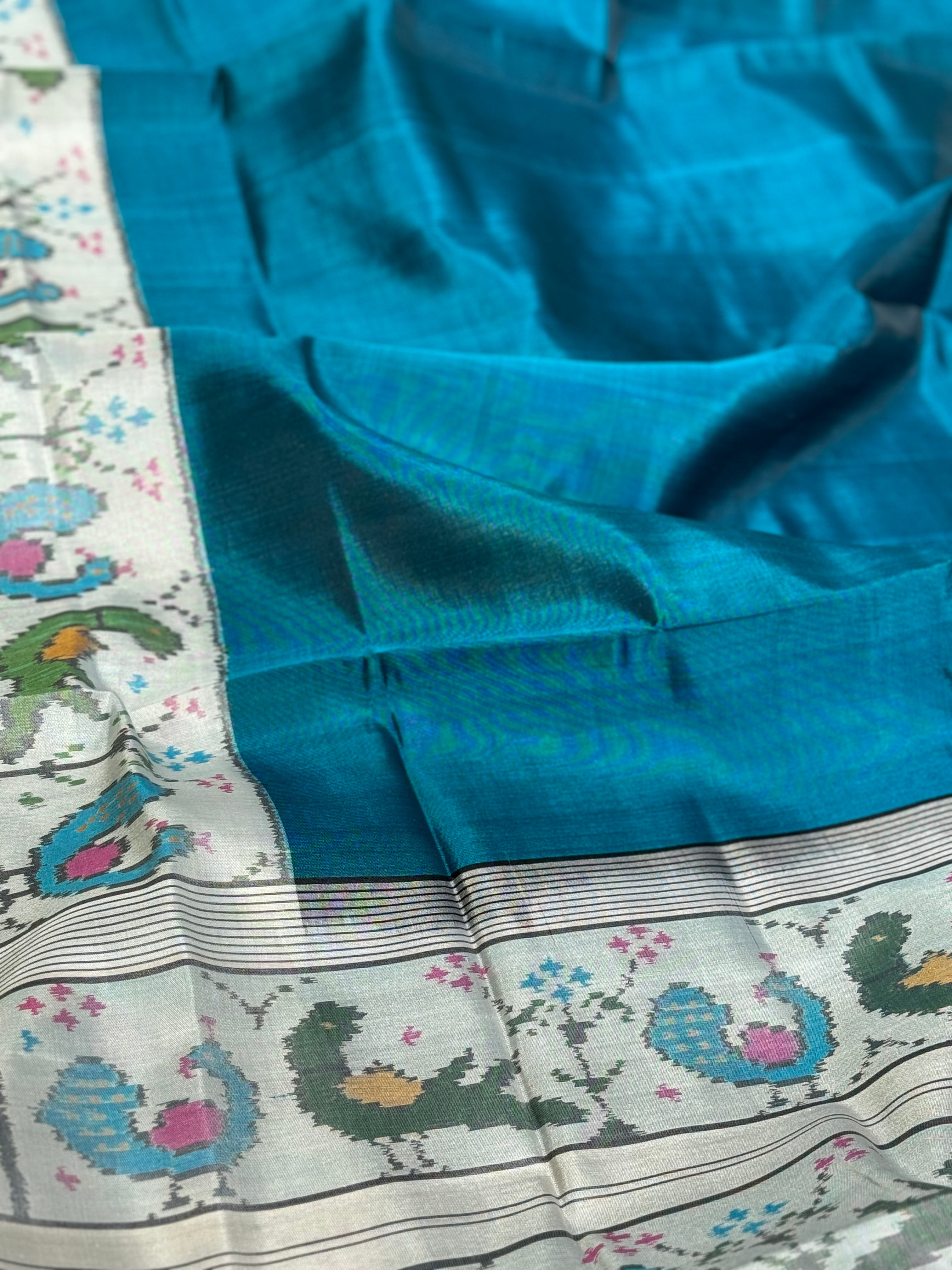 A gorgeous peacock blue with white single ikkat patola silk SAREE with parrot and peacock motifs