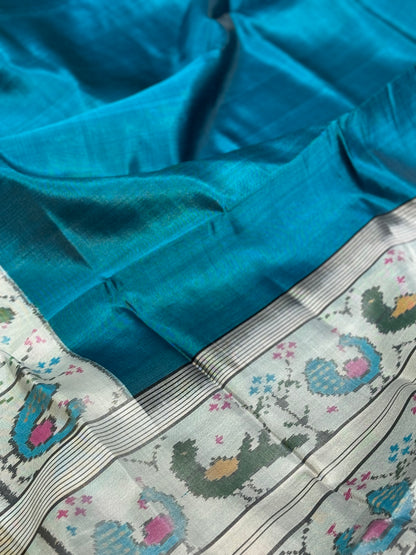 A gorgeous peacock blue with white single ikkat patola silk SAREE with parrot and peacock motifs