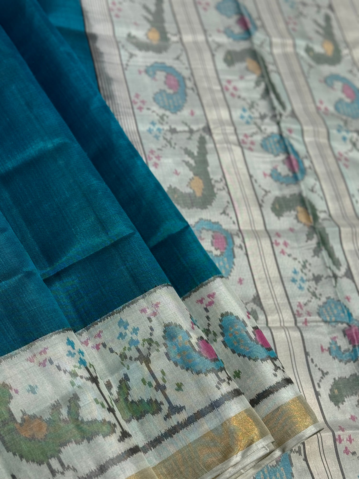 A gorgeous peacock blue with white single ikkat patola silk SAREE with parrot and peacock motifs