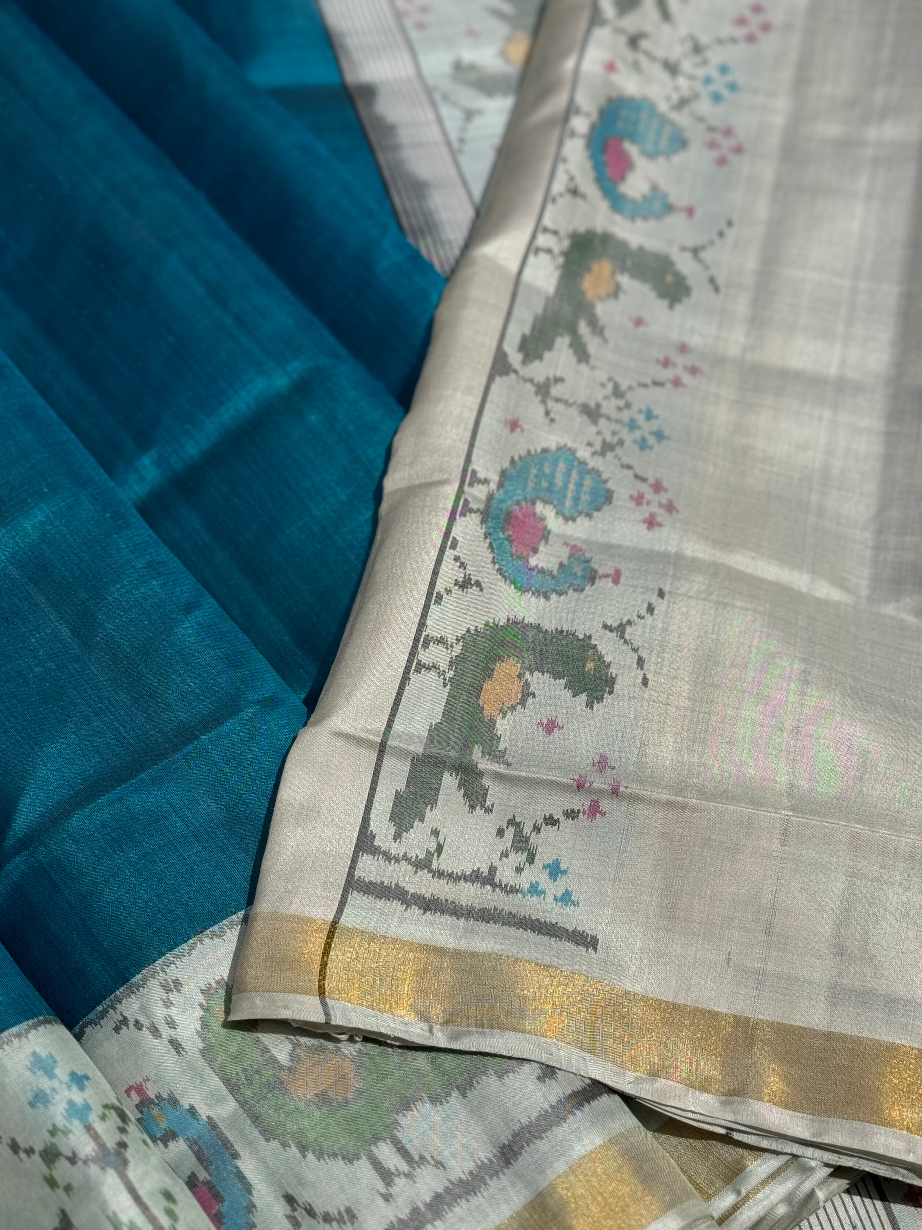 A gorgeous peacock blue with white single ikkat patola silk SAREE with parrot and peacock motifs