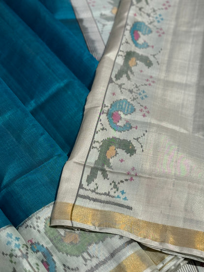 A gorgeous peacock blue with white single ikkat patola silk SAREE with parrot and peacock motifs