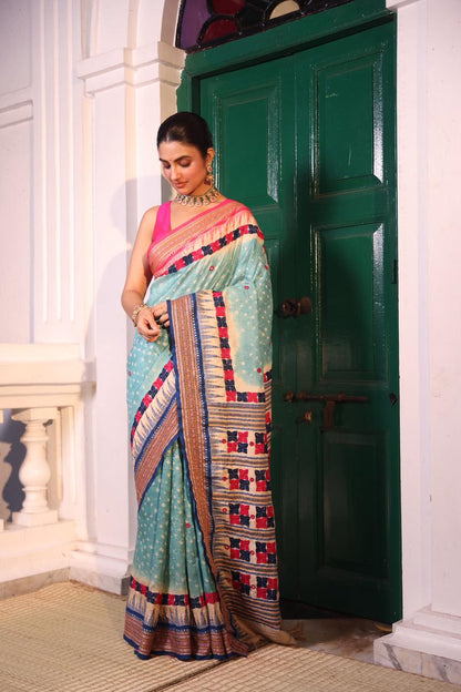 An exquisite handwoven vidharbha tussar silk saree with karvati kinar border intricately tie dyed with turquoise blue bhandhej and phulkari hand embroidered