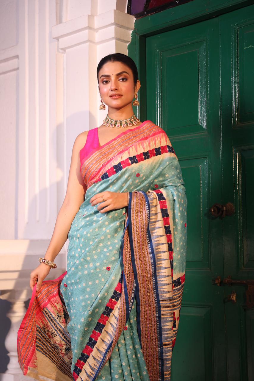 An exquisite handwoven vidharbha tussar silk saree with karvati kinar border intricately tie dyed with turquoise blue bhandhej and phulkari hand embroidered