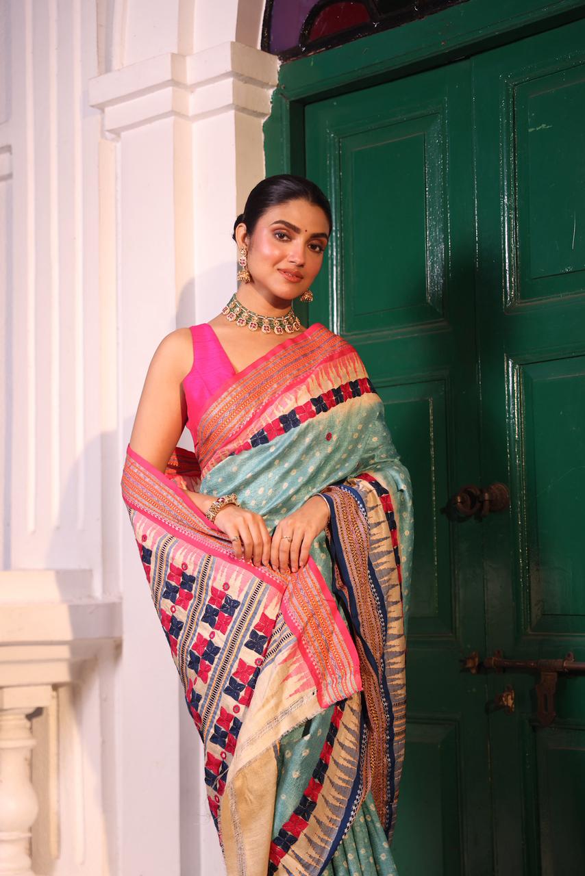 An exquisite handwoven vidharbha tussar silk saree with karvati kinar border intricately tie dyed with turquoise blue bhandhej and phulkari hand embroidered