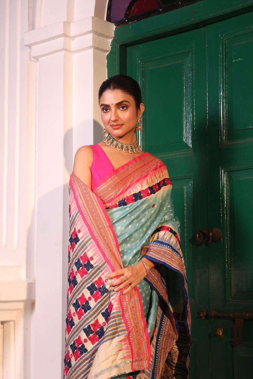 An exquisite handwoven vidharbha tussar silk saree with karvati kinar border intricately tie dyed with turquoise blue bhandhej and phulkari hand embroidered
