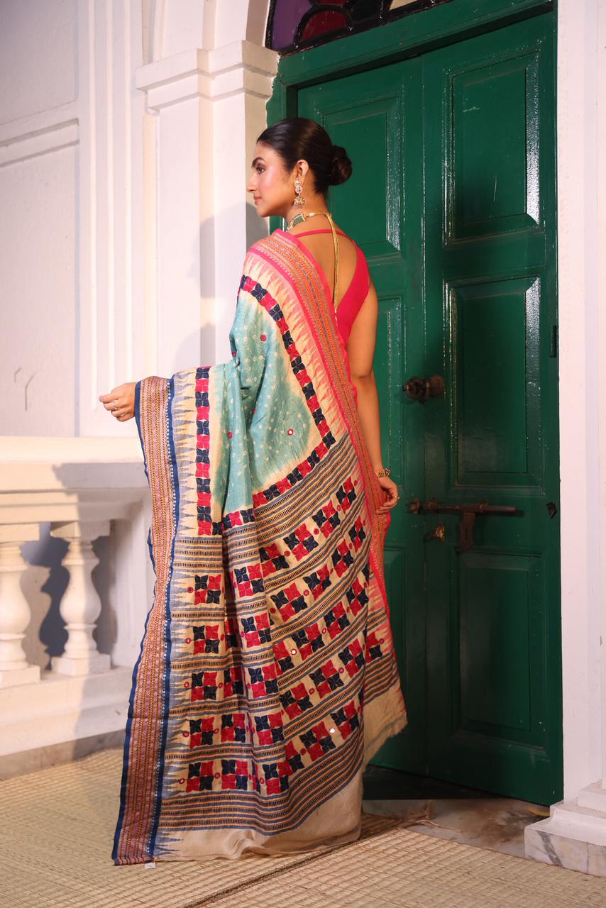 An exquisite handwoven vidharbha tussar silk saree with karvati kinar border intricately tie dyed with turquoise blue bhandhej and phulkari hand embroidered