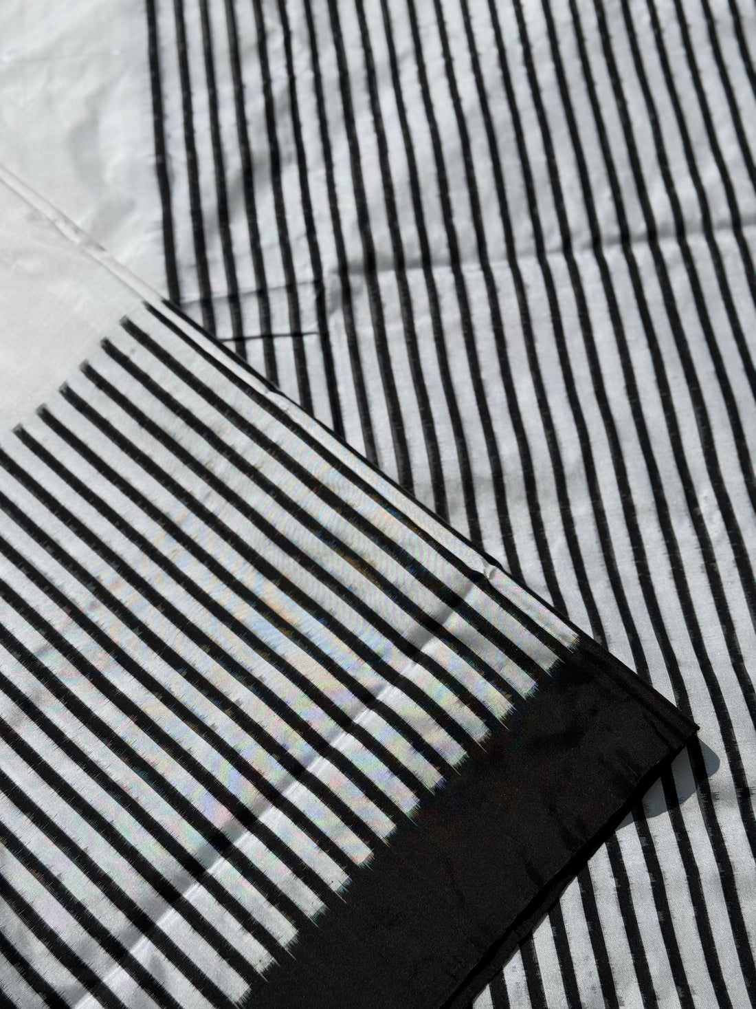 A double warp and weft tie dyed ikkat handwoven saree in pure mulberry silk with contemporary style of design