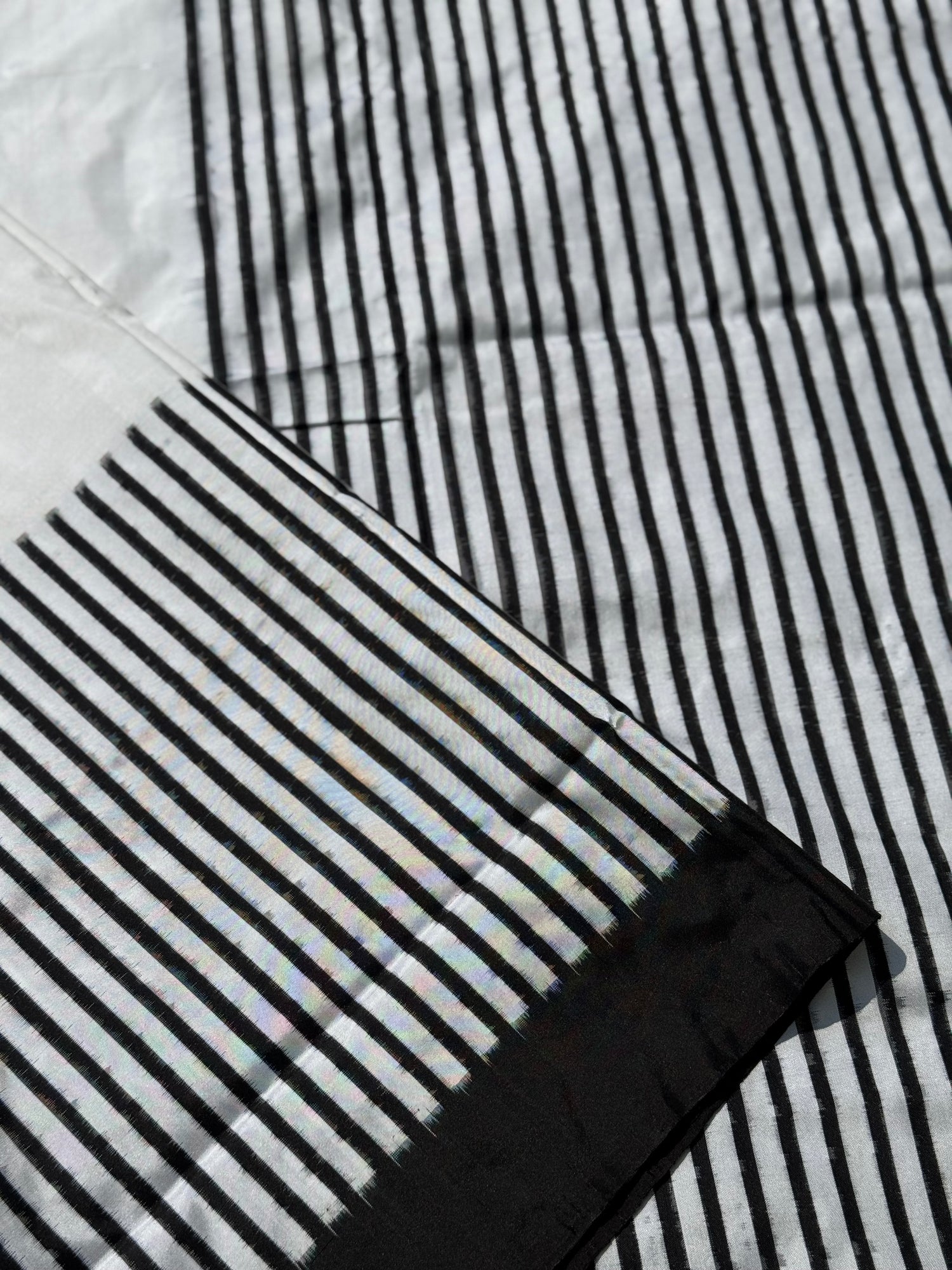 A double warp and weft tie dyed ikkat handwoven saree in pure mulberry silk with contemporary style of design