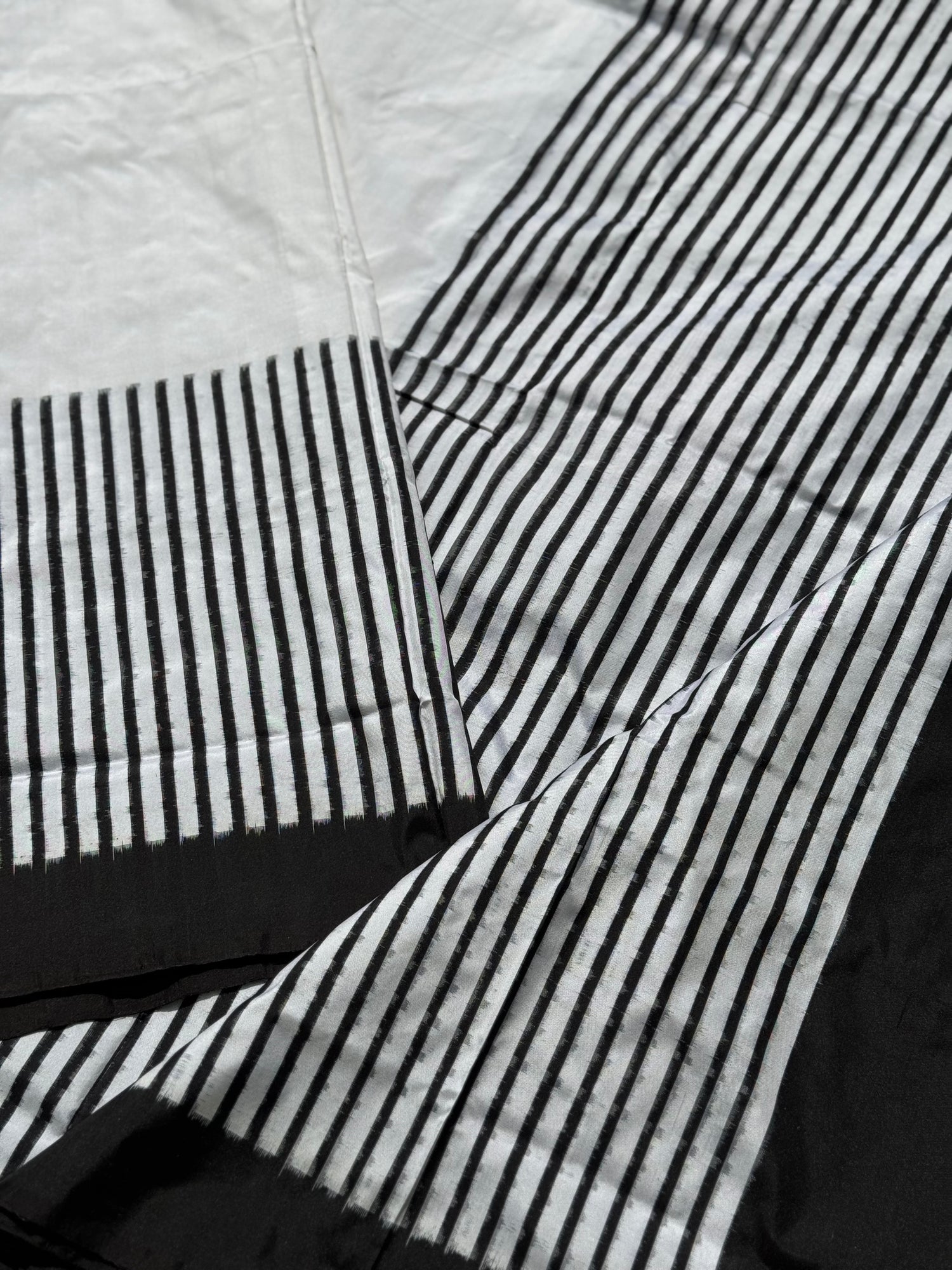 A double warp and weft tie dyed ikkat handwoven saree in pure mulberry silk with contemporary style of design