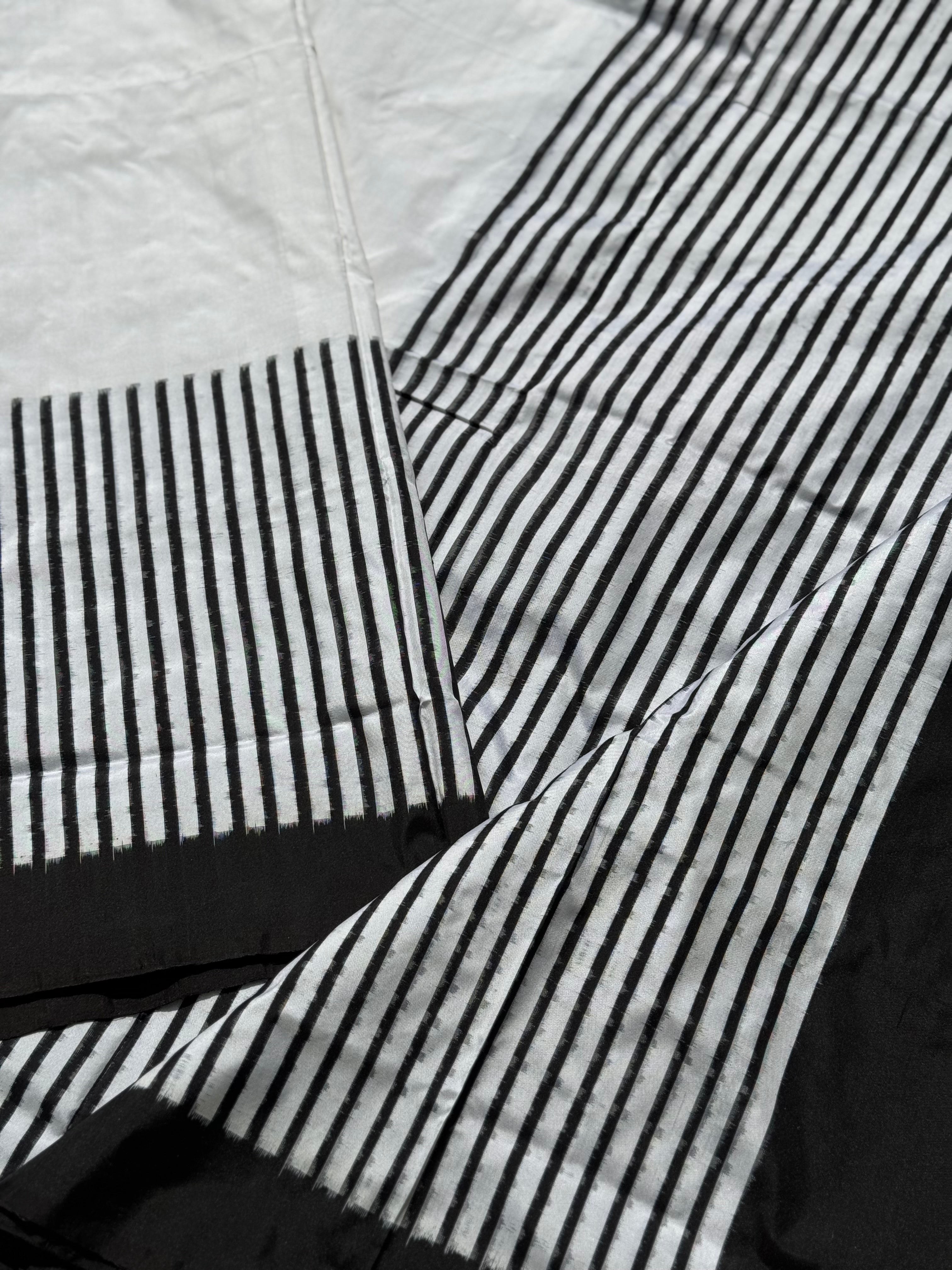 A double warp and weft tie dyed ikkat handwoven saree in pure mulberry silk with contemporary style of design