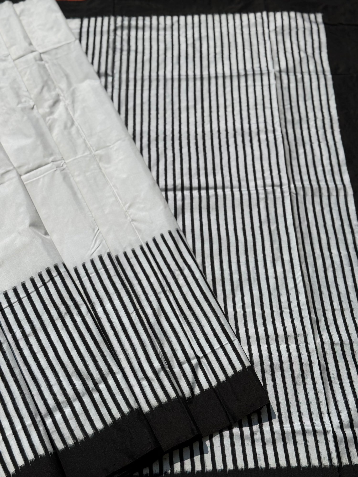 A double warp and weft tie dyed ikkat handwoven saree in pure mulberry silk with contemporary style of design