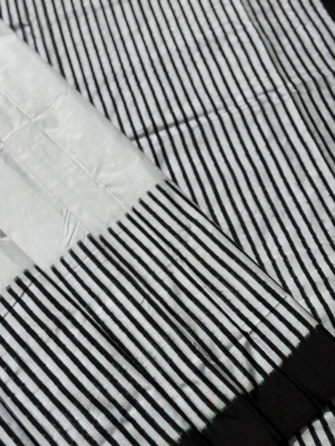 A double warp and weft tie dyed ikkat handwoven saree in pure mulberry silk with contemporary style of design