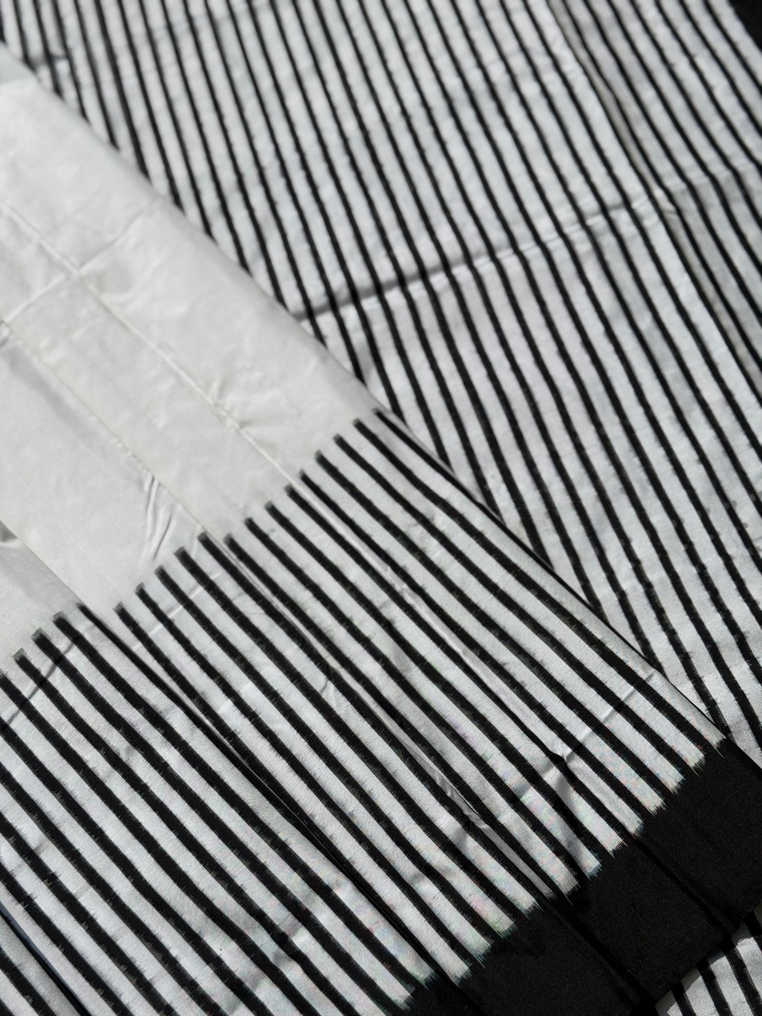 A double warp and weft tie dyed ikkat handwoven saree in pure mulberry silk with contemporary style of design