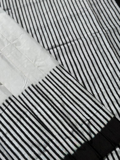 A double warp and weft tie dyed ikkat handwoven saree in pure mulberry silk with contemporary style of design