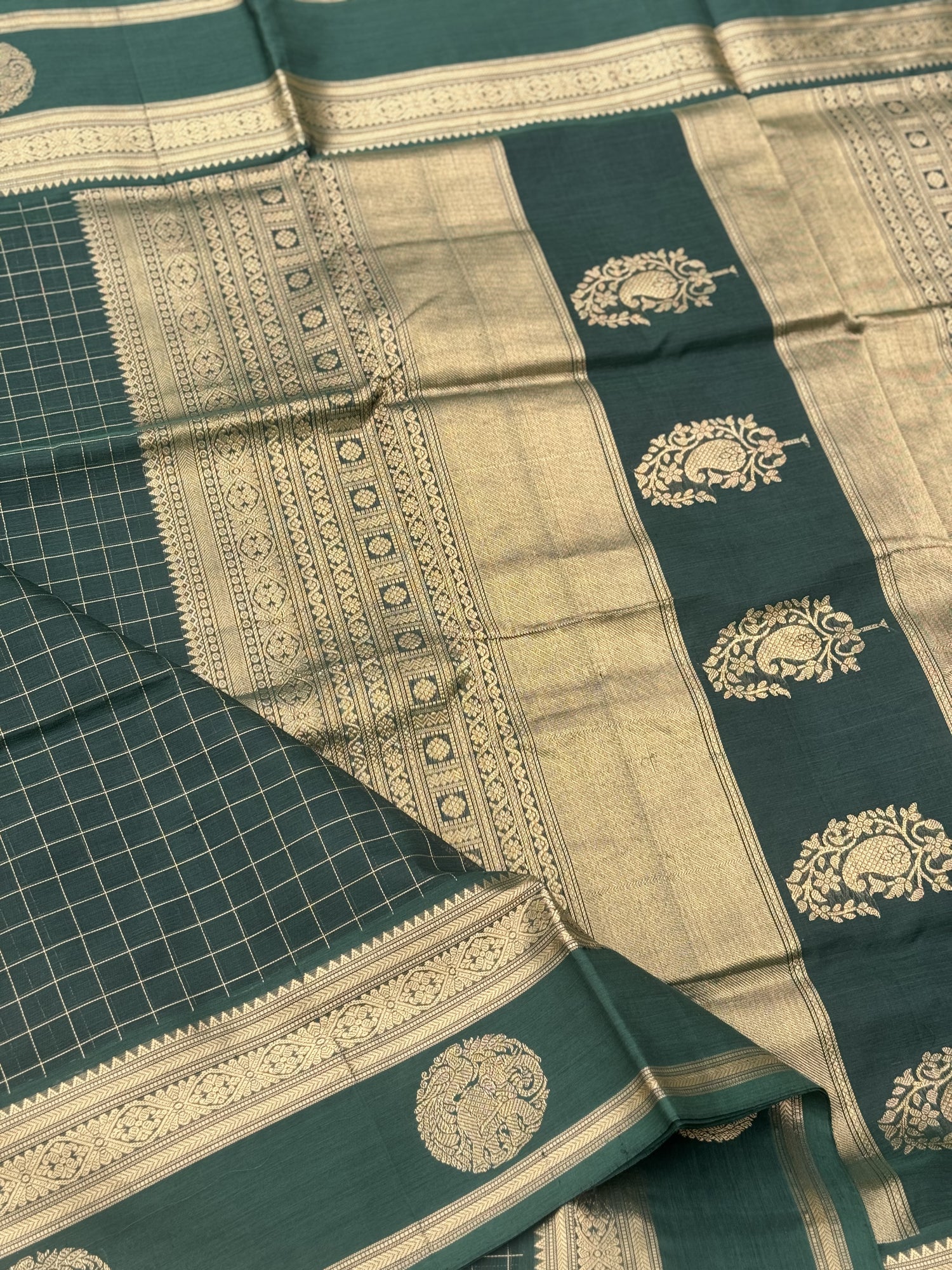 A gorgeous bottlegreen shade handwoven zari kattam Kanchi silk cotton saree