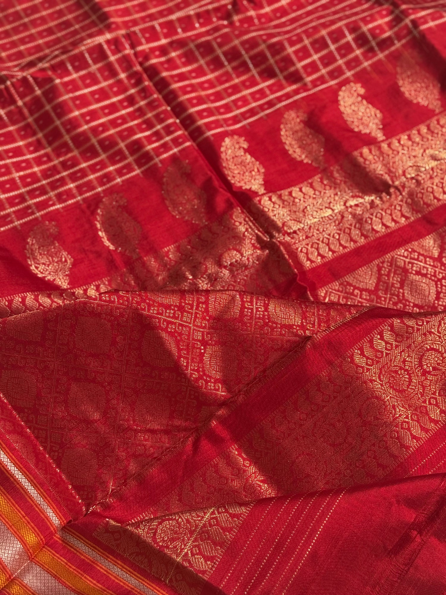 A masterpiece piece red shade weft single ikkat tie dyed handwoven saree in pure mulberry silk with traditional checks