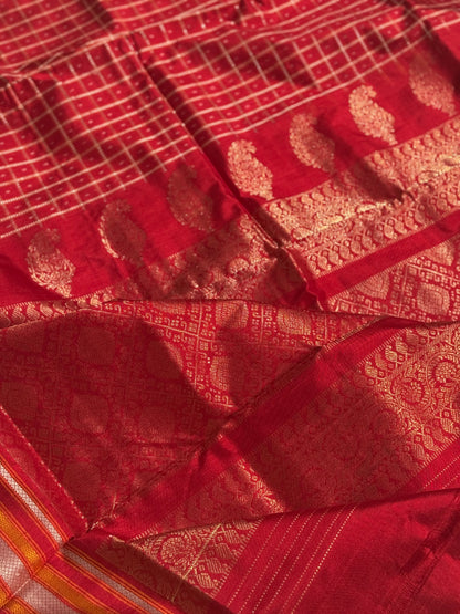 A masterpiece piece red shade weft single ikkat tie dyed handwoven saree in pure mulberry silk with traditional checks