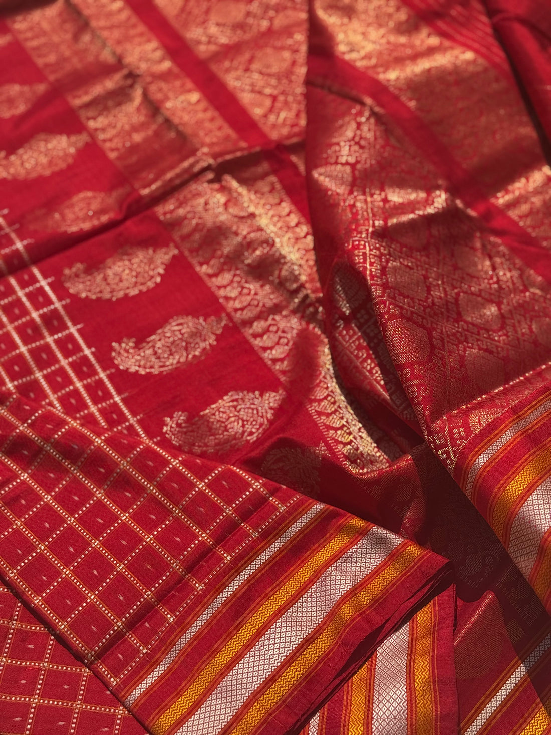 A masterpiece piece red shade weft single ikkat tie dyed handwoven saree in pure mulberry silk with traditional checks