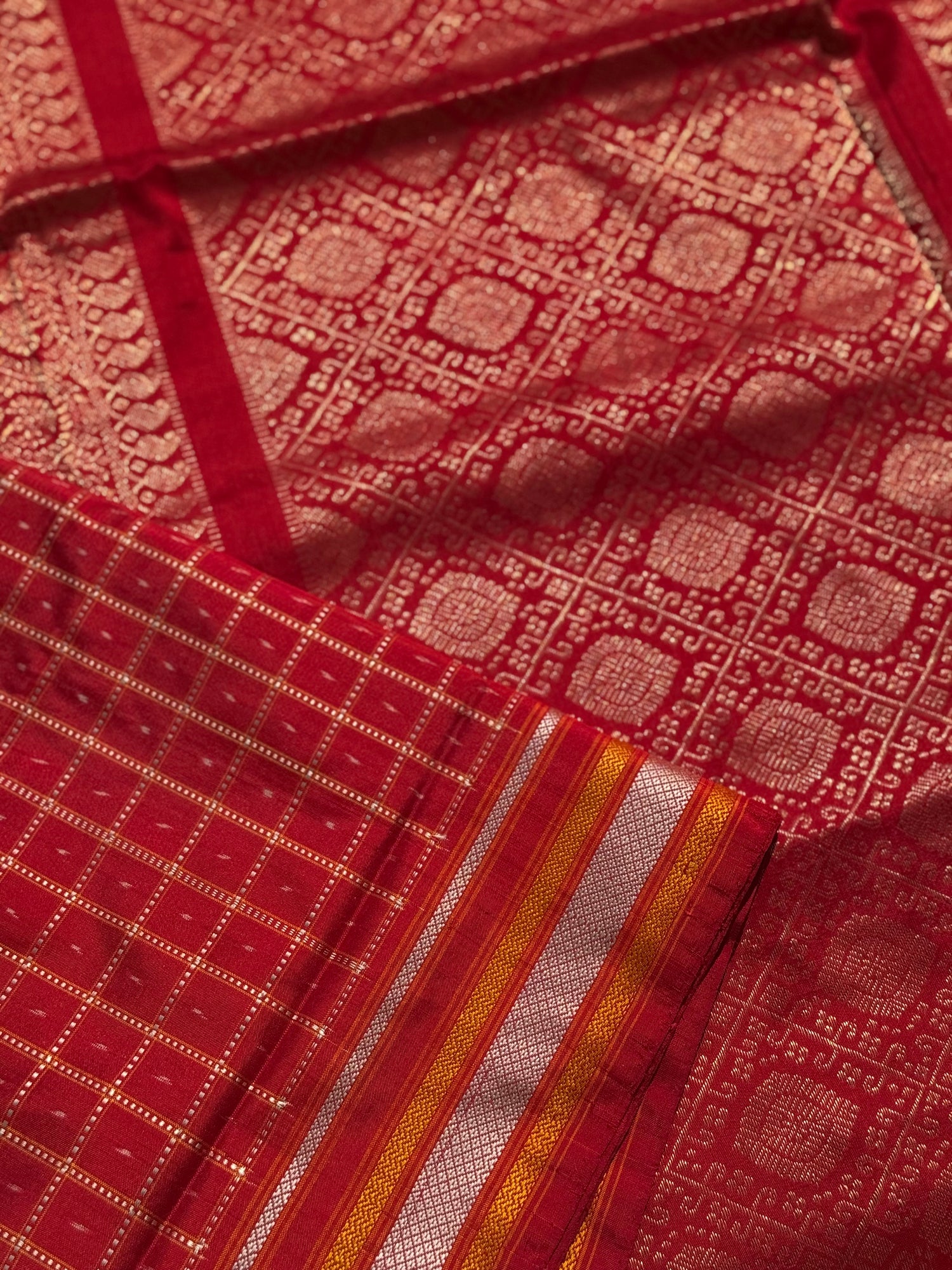 A masterpiece piece red shade weft single ikkat tie dyed handwoven saree in pure mulberry silk with traditional checks