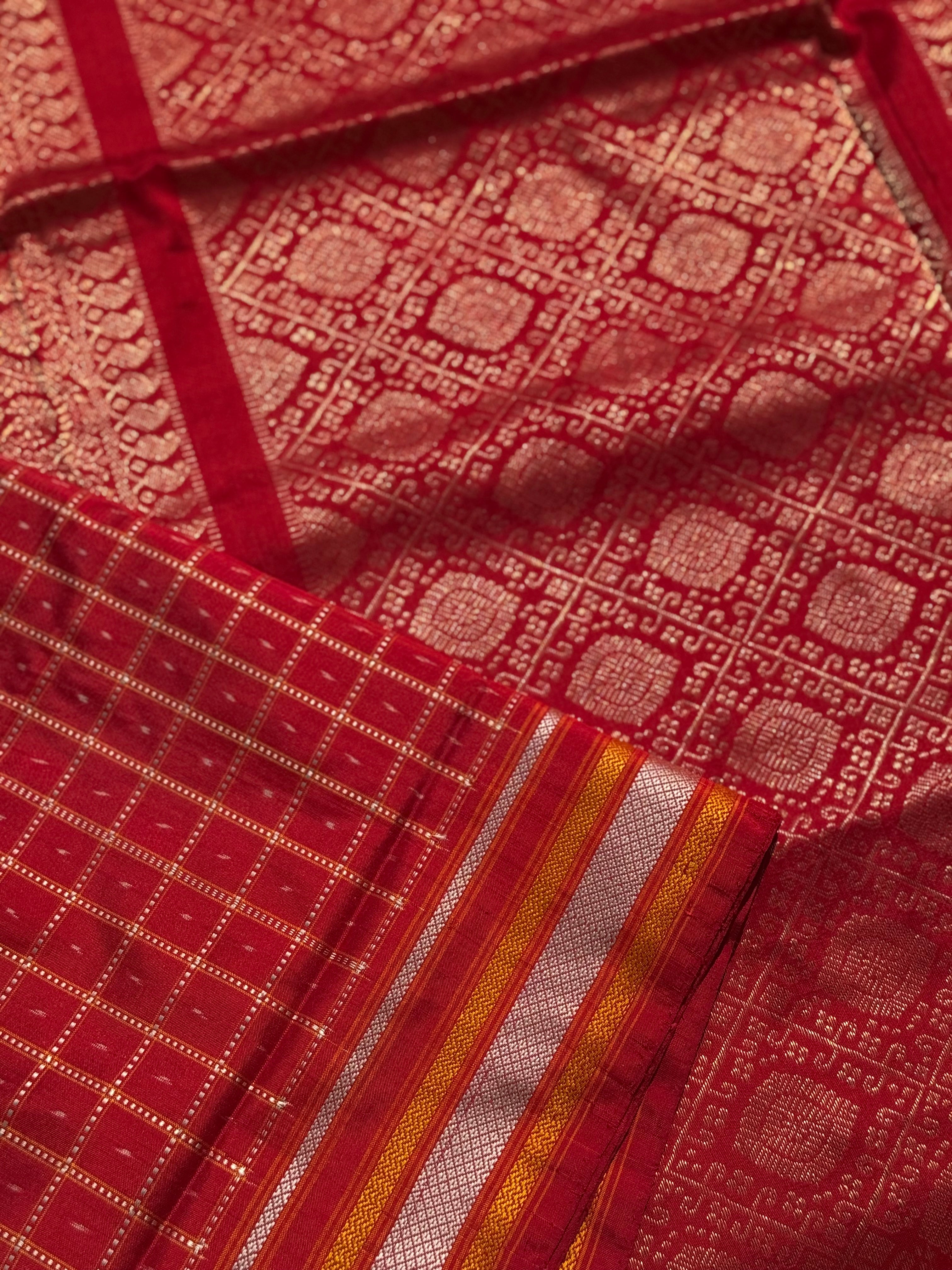 A masterpiece piece red shade weft single ikkat tie dyed handwoven saree in pure mulberry silk with traditional checks