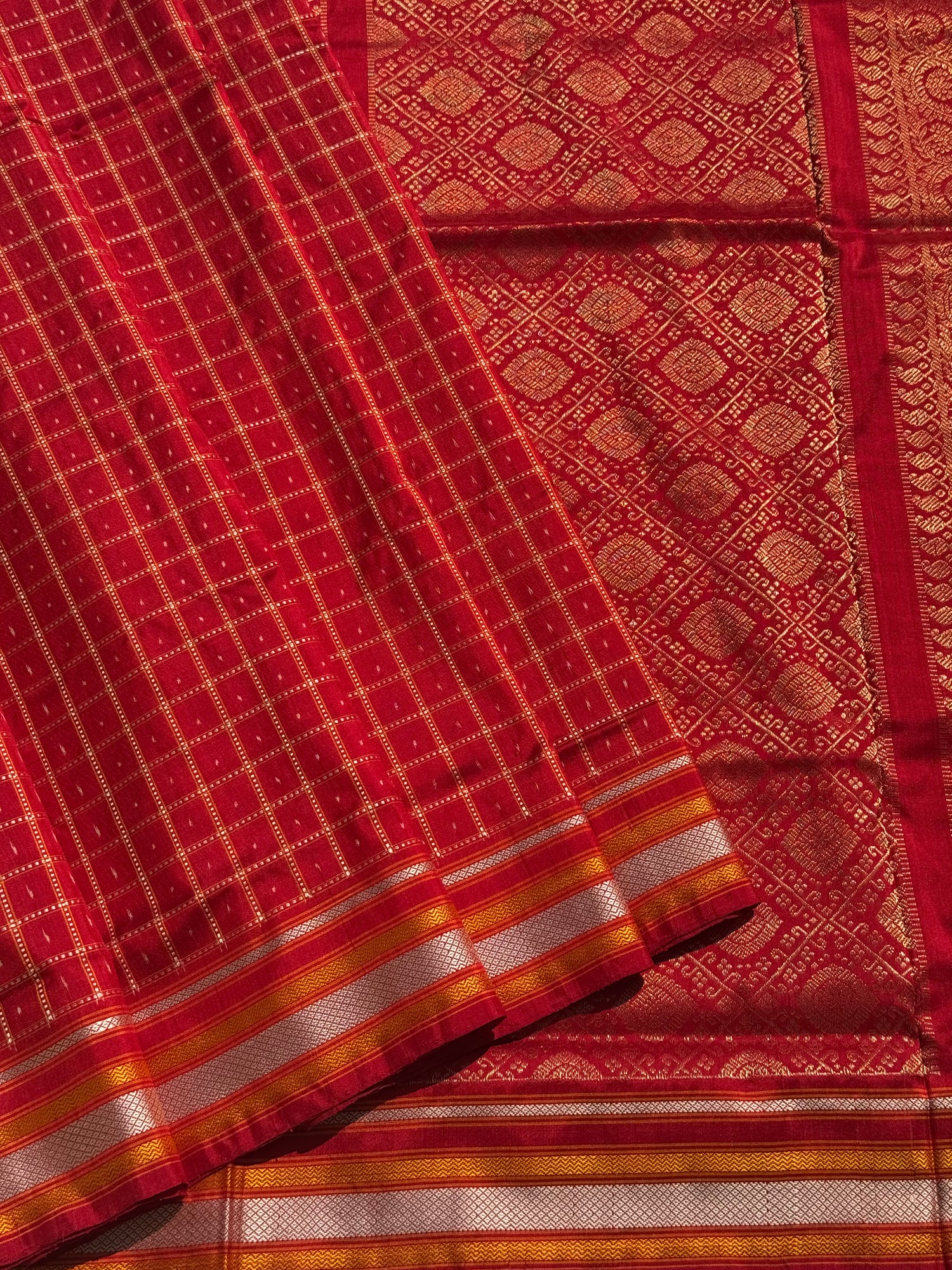 A masterpiece piece red shade weft single ikkat tie dyed handwoven saree in pure mulberry silk with traditional checks