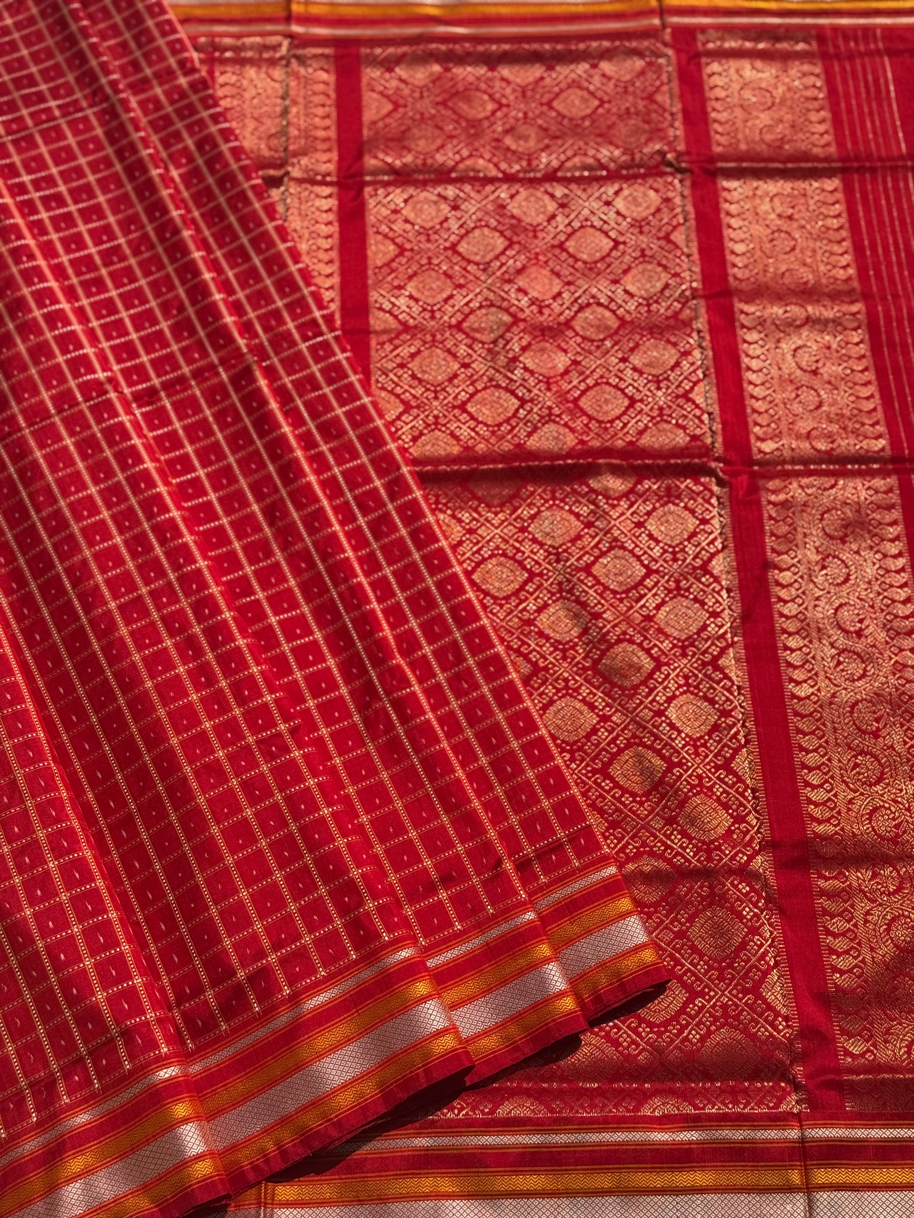 A masterpiece piece red shade weft single ikkat tie dyed handwoven saree in pure mulberry silk with traditional checks
