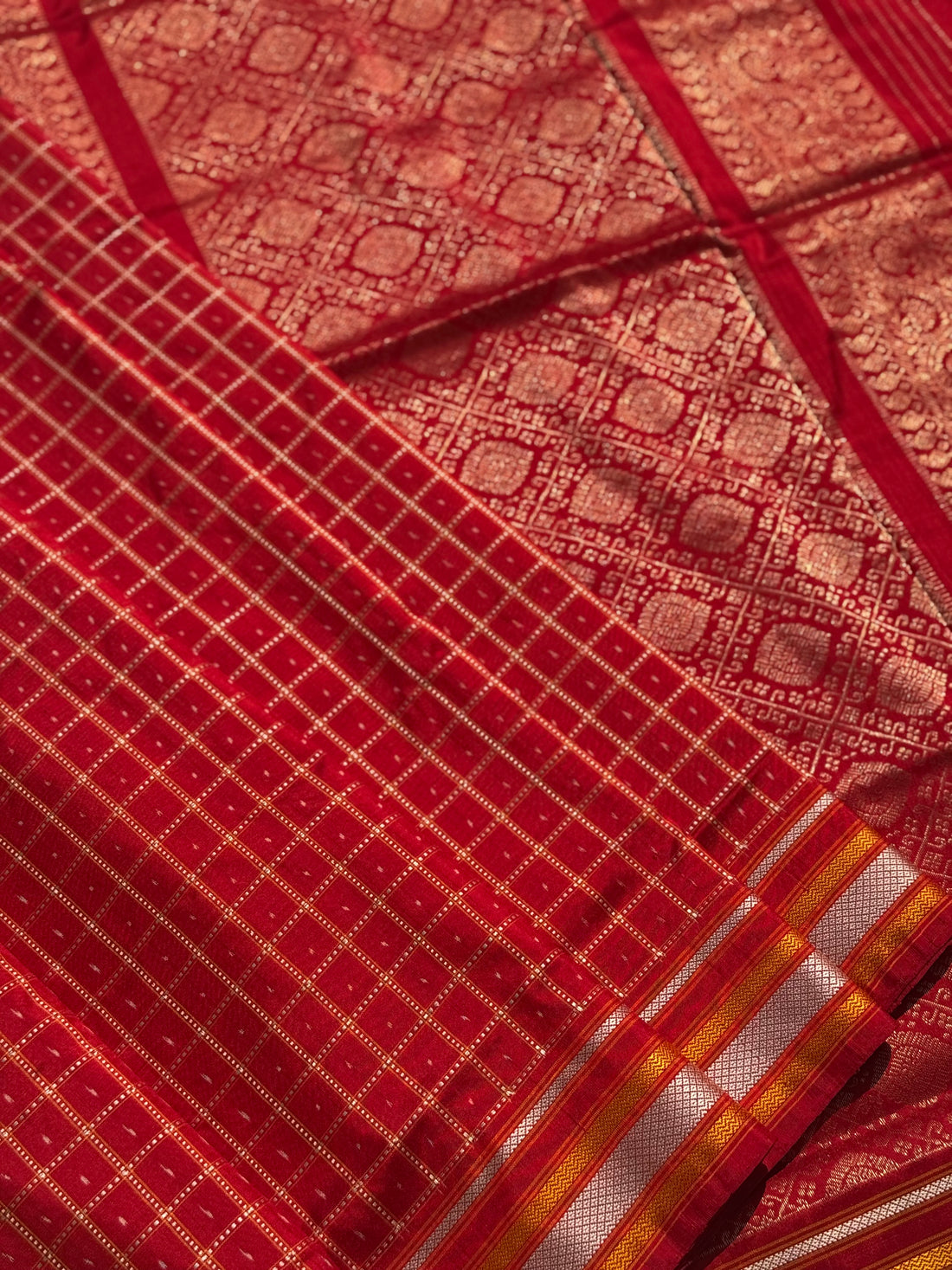 A masterpiece piece red shade weft single ikkat tie dyed handwoven saree in pure mulberry silk with traditional checks