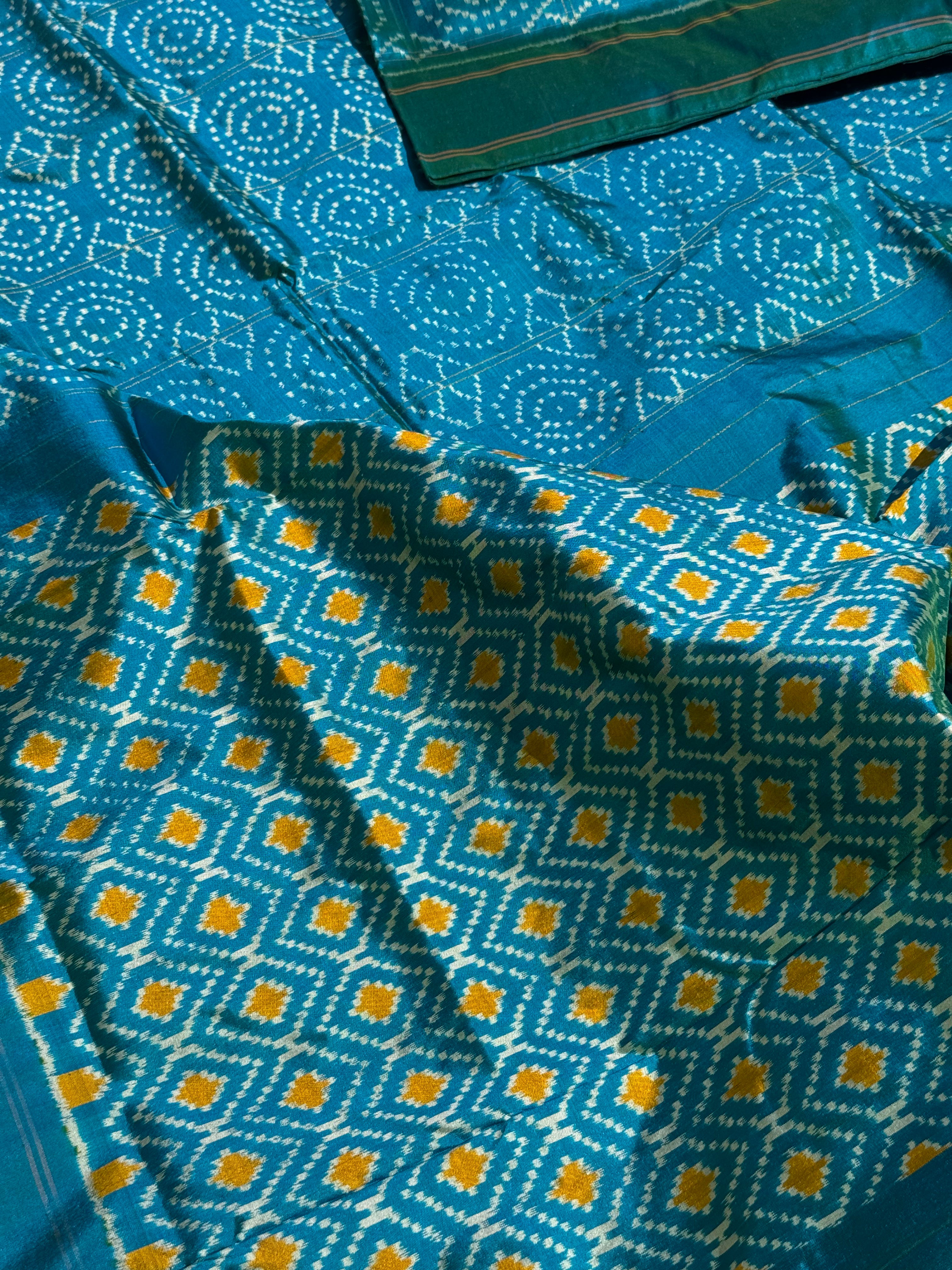 A masterpiece ikkat handwoven weft ikkat saree in pure mulberry silk in teal shade with complete zari checks on body