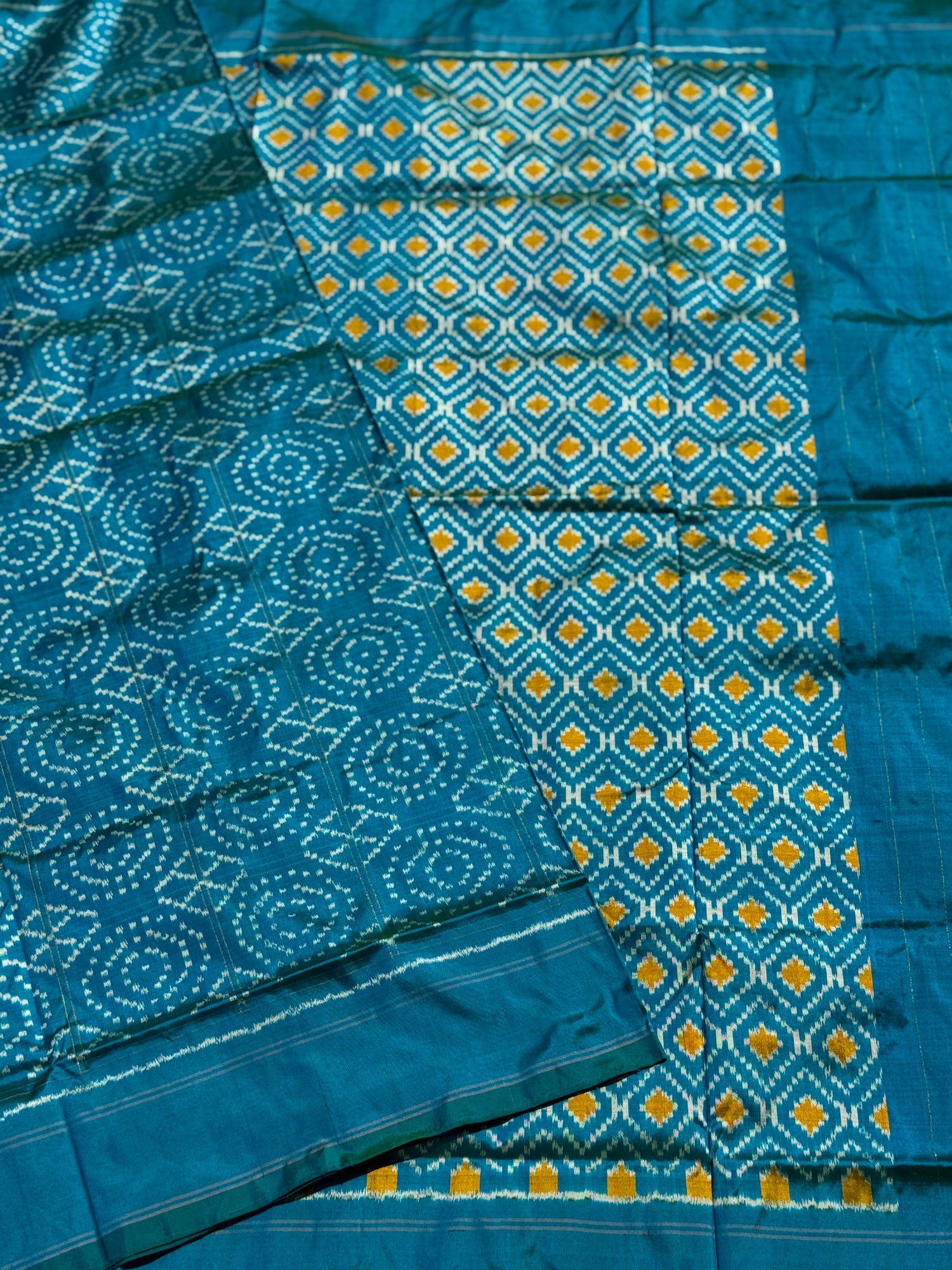 A masterpiece ikkat handwoven weft ikkat saree in pure mulberry silk in teal shade with complete zari checks on body