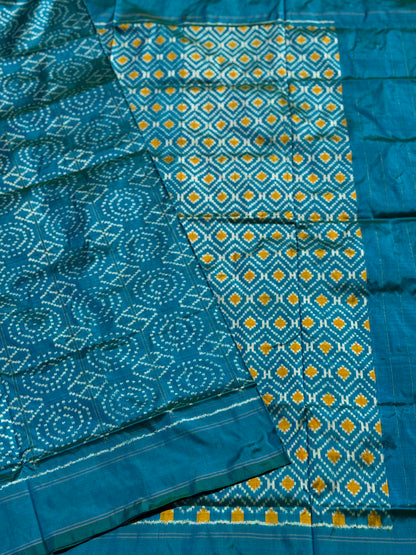 A masterpiece ikkat handwoven weft ikkat saree in pure mulberry silk in teal shade with complete zari checks on body