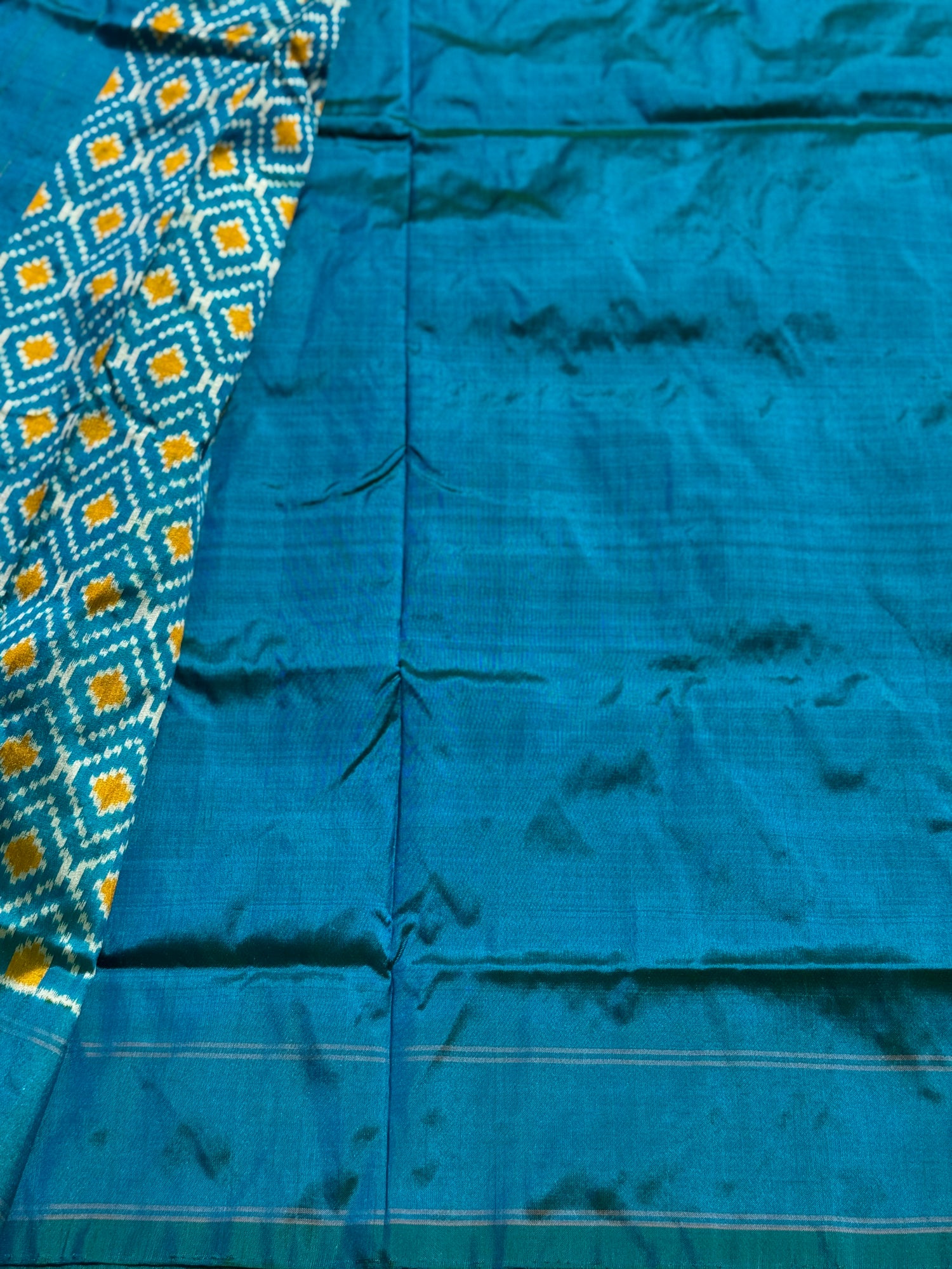 A masterpiece ikkat handwoven weft ikkat saree in pure mulberry silk in teal shade with complete zari checks on body