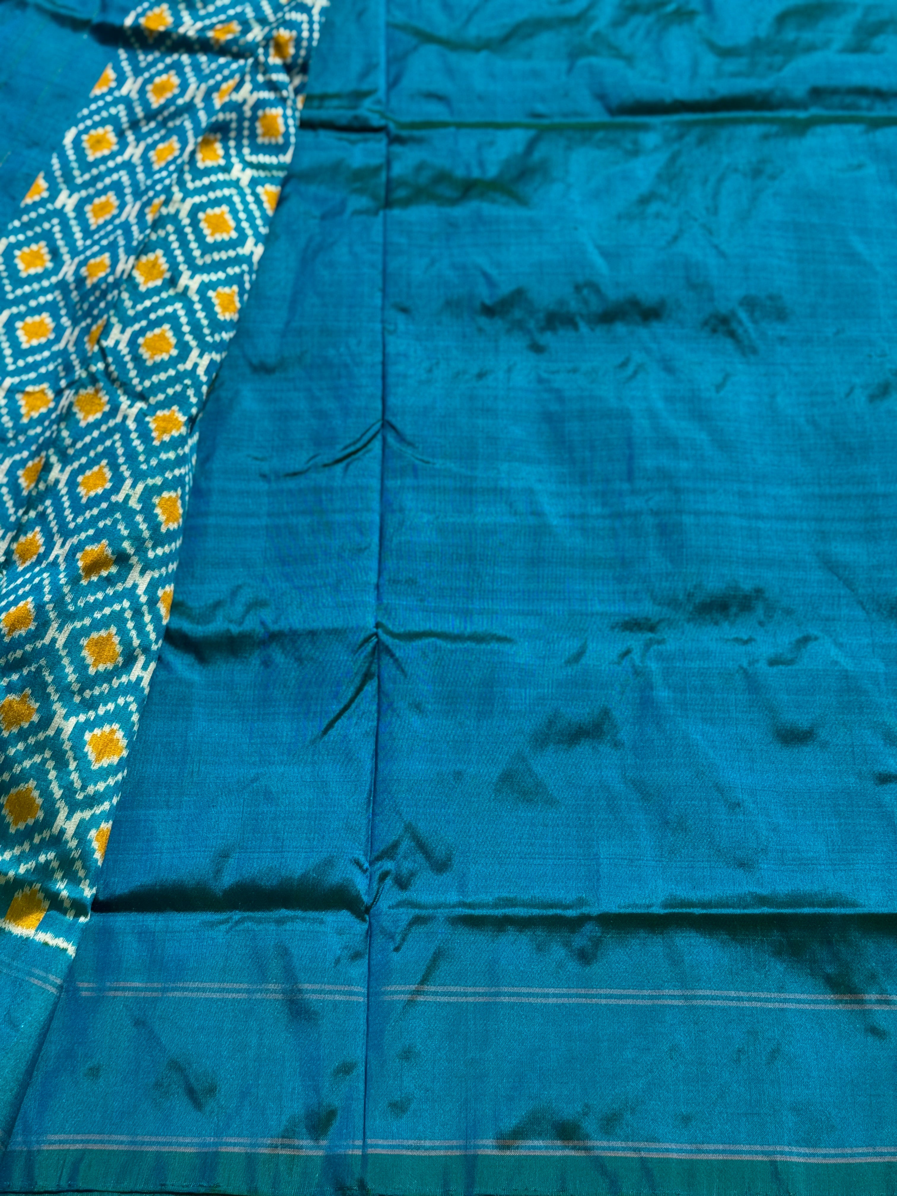 A masterpiece ikkat handwoven weft ikkat saree in pure mulberry silk in teal shade with complete zari checks on body