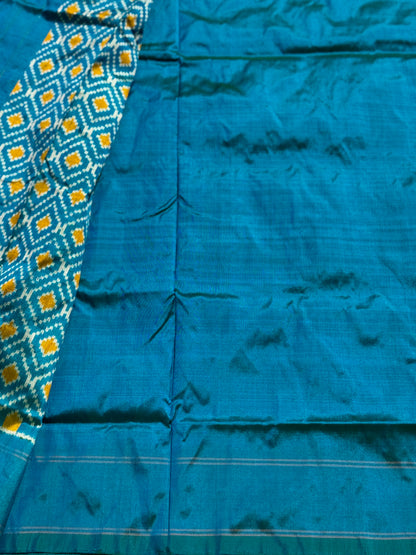 A masterpiece ikkat handwoven weft ikkat saree in pure mulberry silk in teal shade with complete zari checks on body
